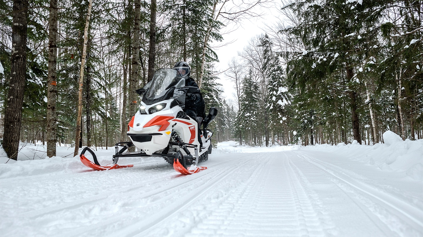Lynx Adventure Electric snowmobile riding quiet on trail