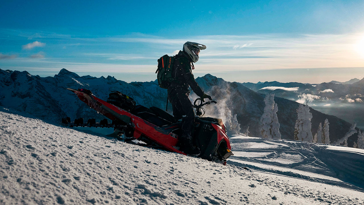 Shredder DS snowmobile parking in downhill at mountains