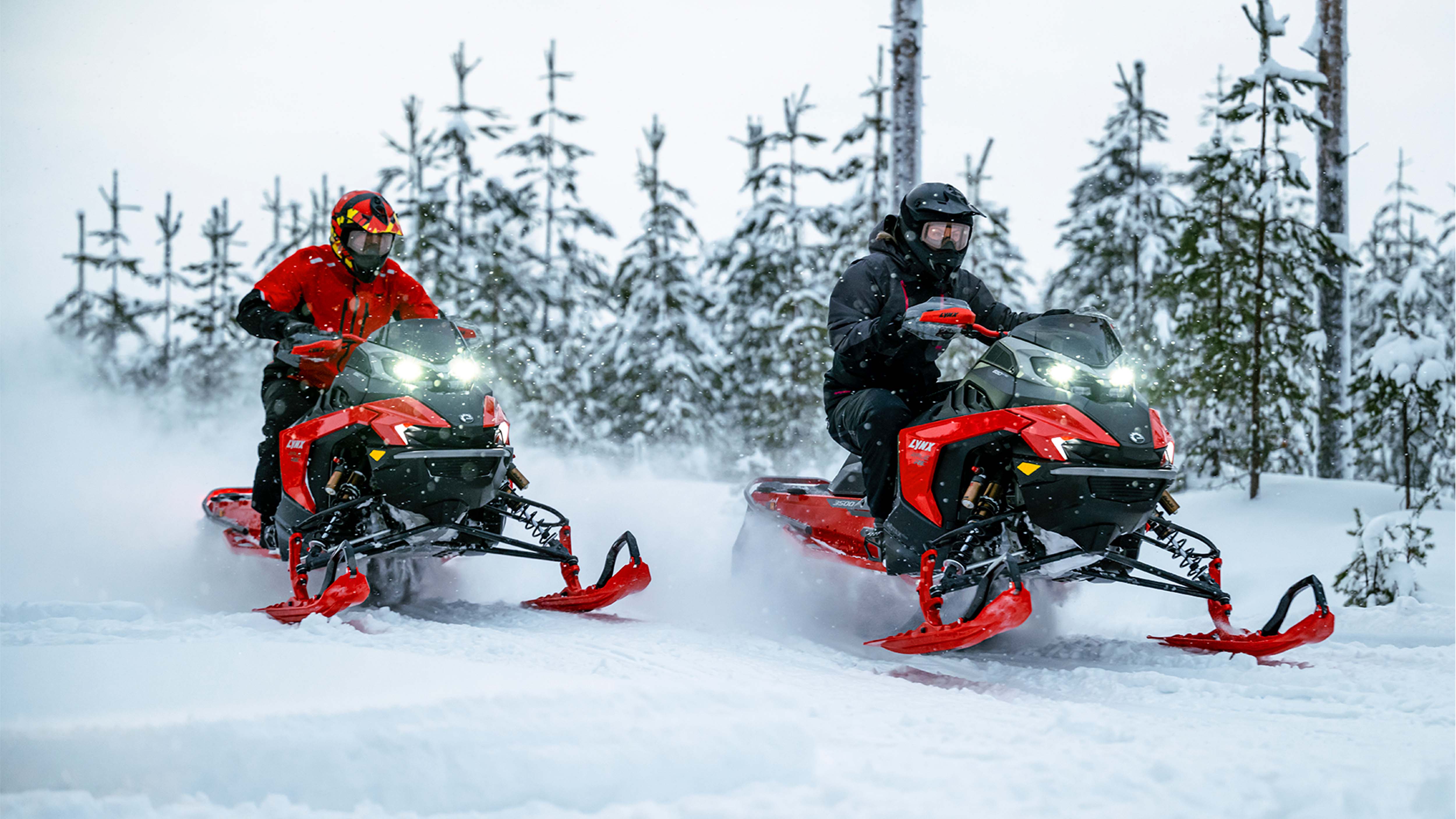 Two Lynx Rave RE snowmobiles riding on trail side by side