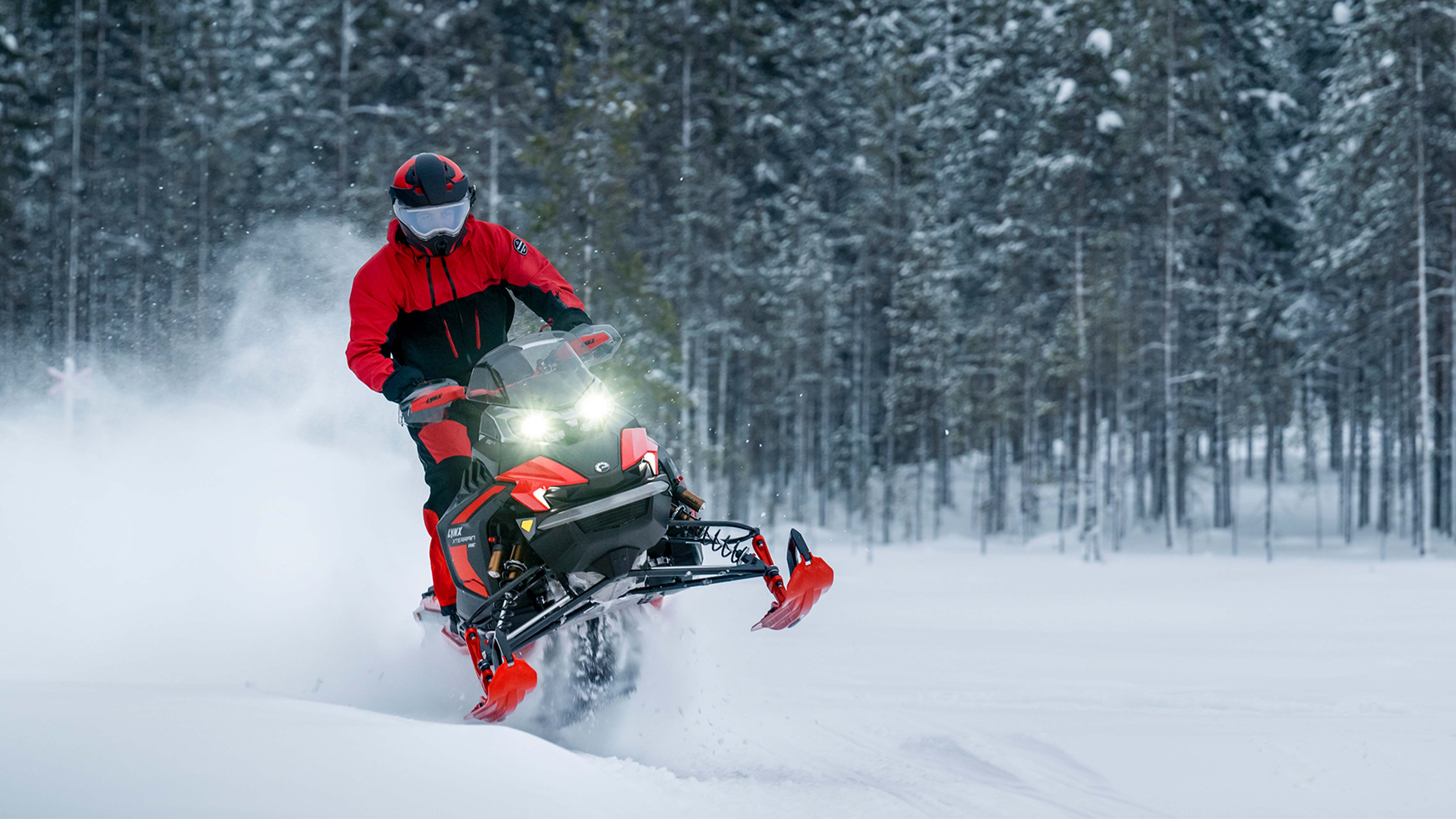 Lynx Xterrain RE snowmobile accelerating on snowy trail