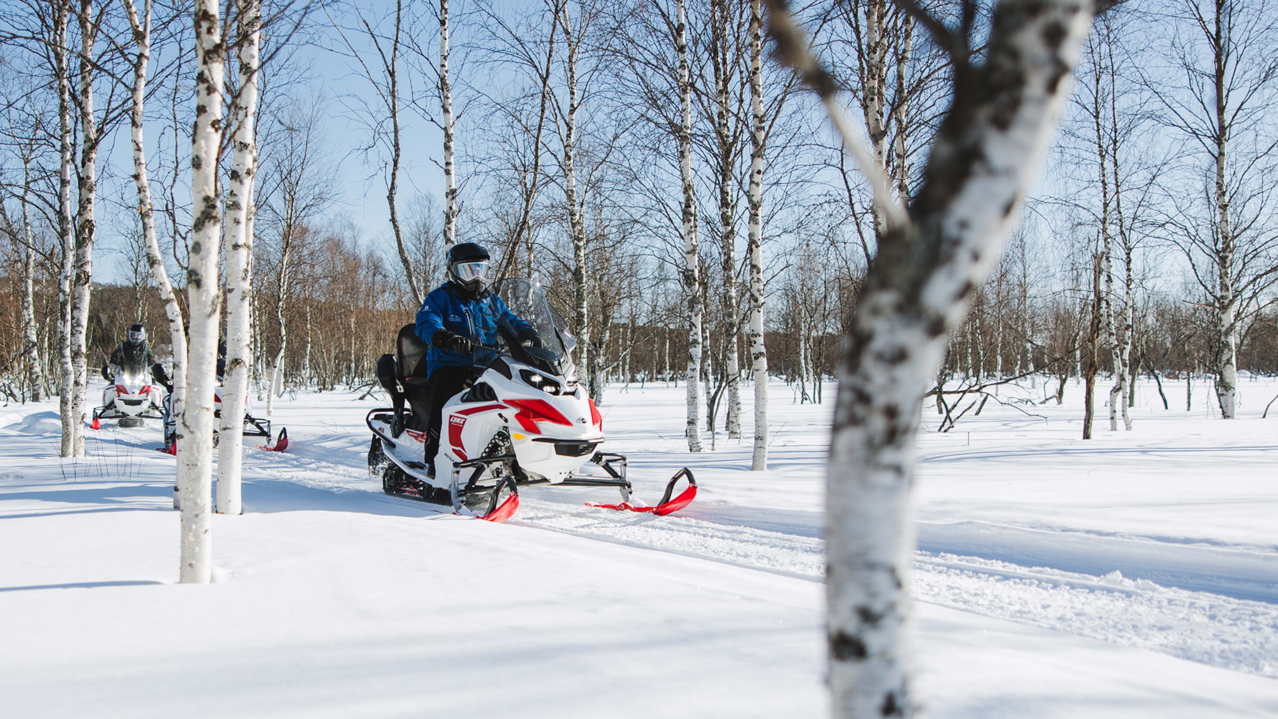 Lynx Adventure Electic snowmobile riding corner on forest trail