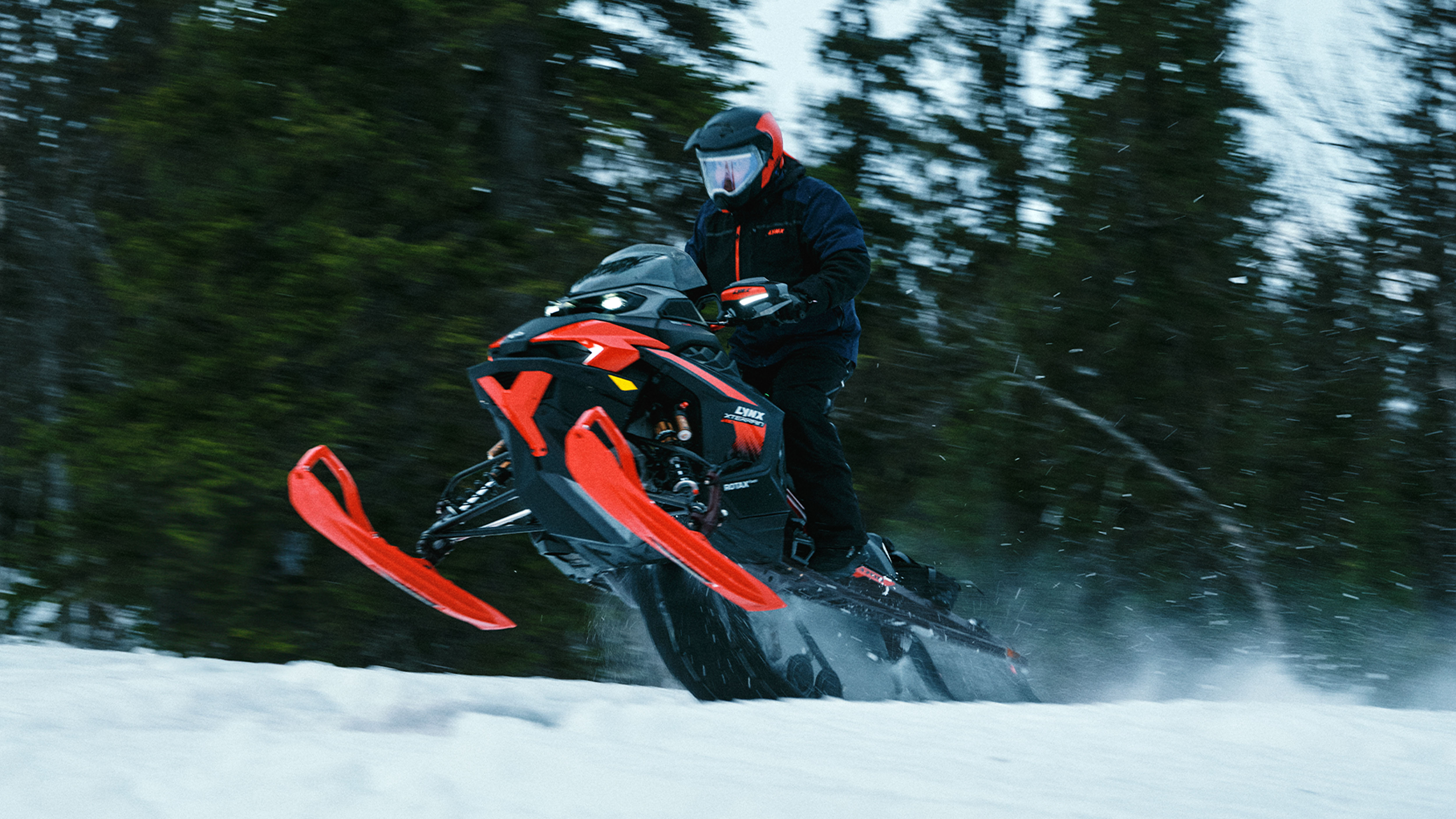 Lynx Xterrain RE 850 E-TEC Turbo R 2025 snowmobile accelerating on trail