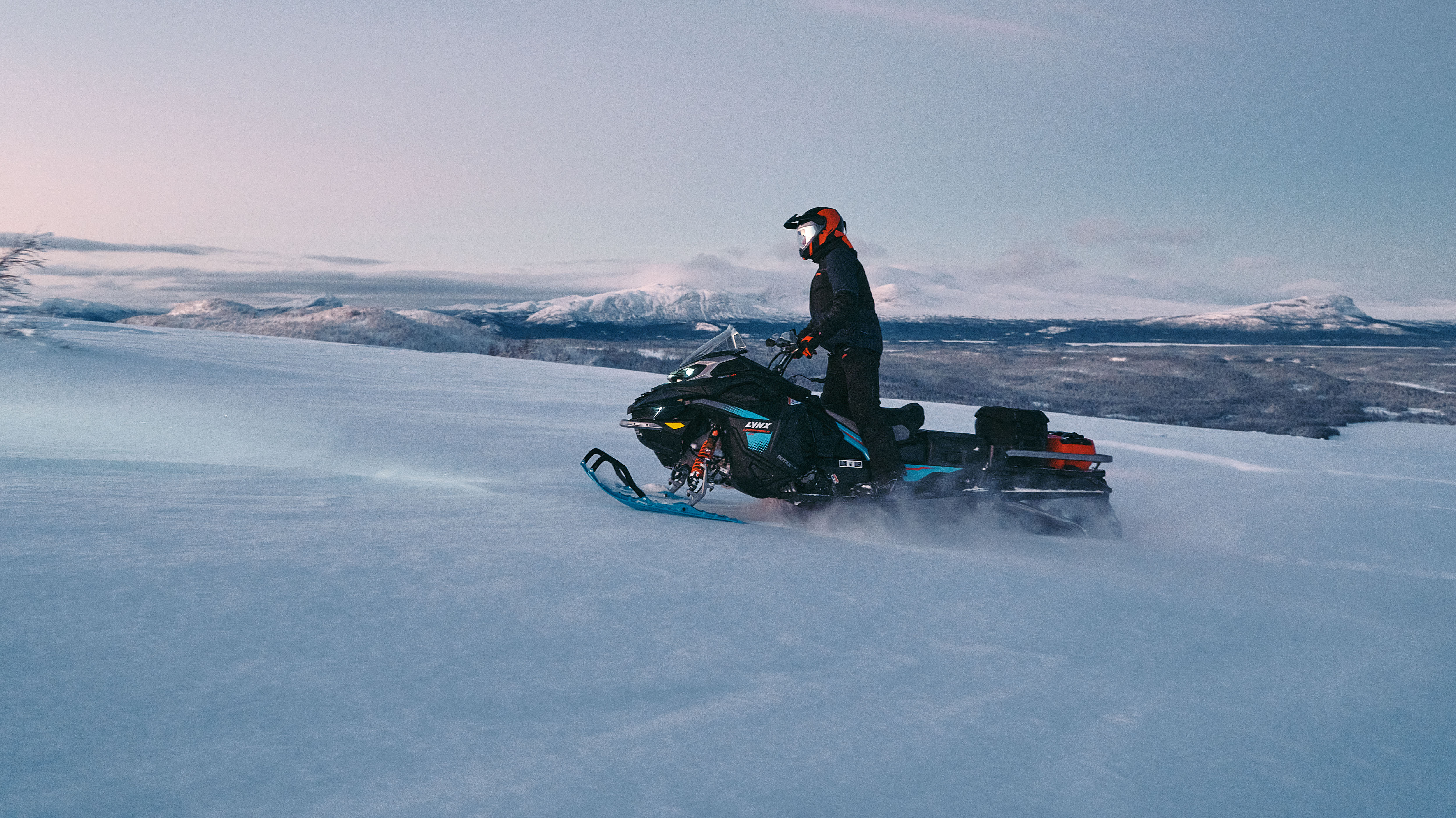 2026 Lynx Commander RE snowmobile riding uphill 