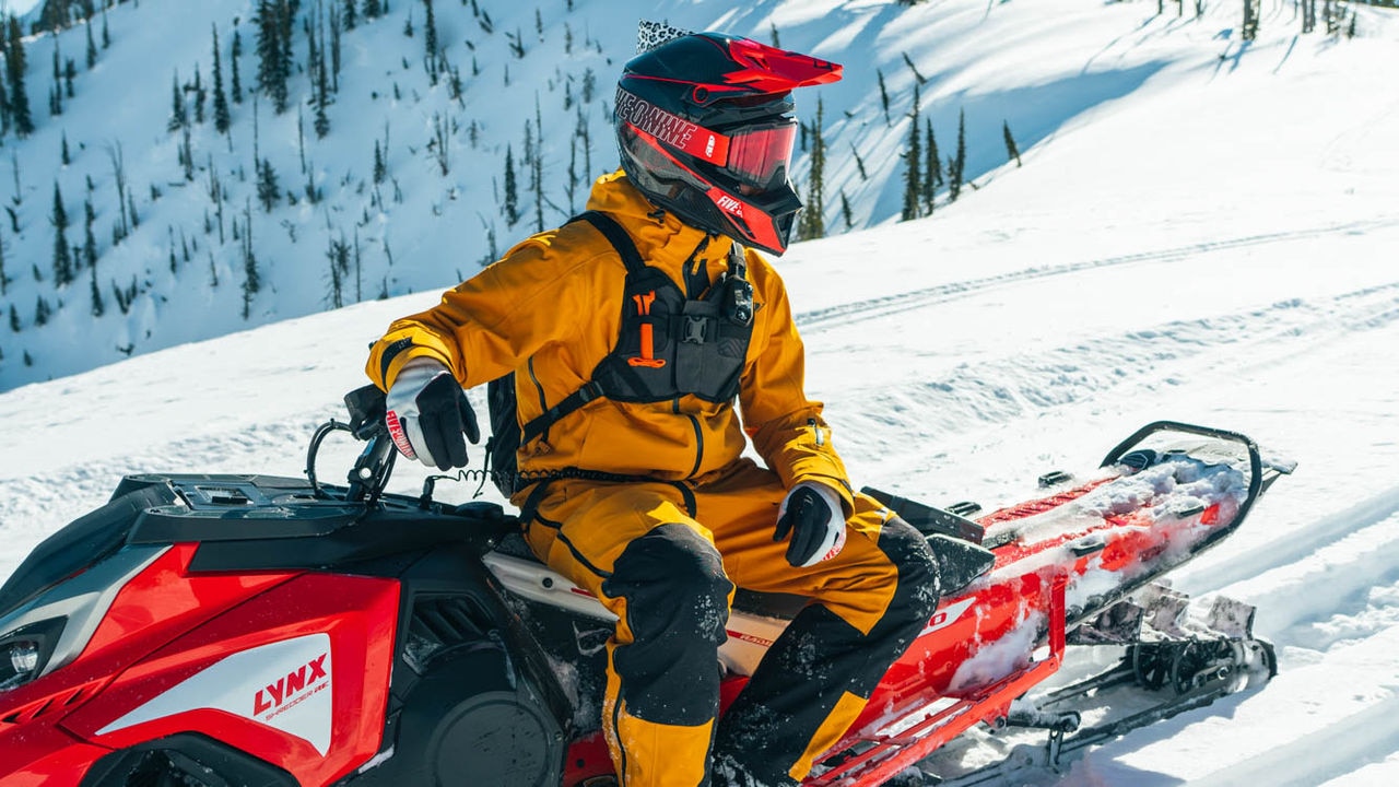 Ross Robinson sitting on a Lynx snowmobile