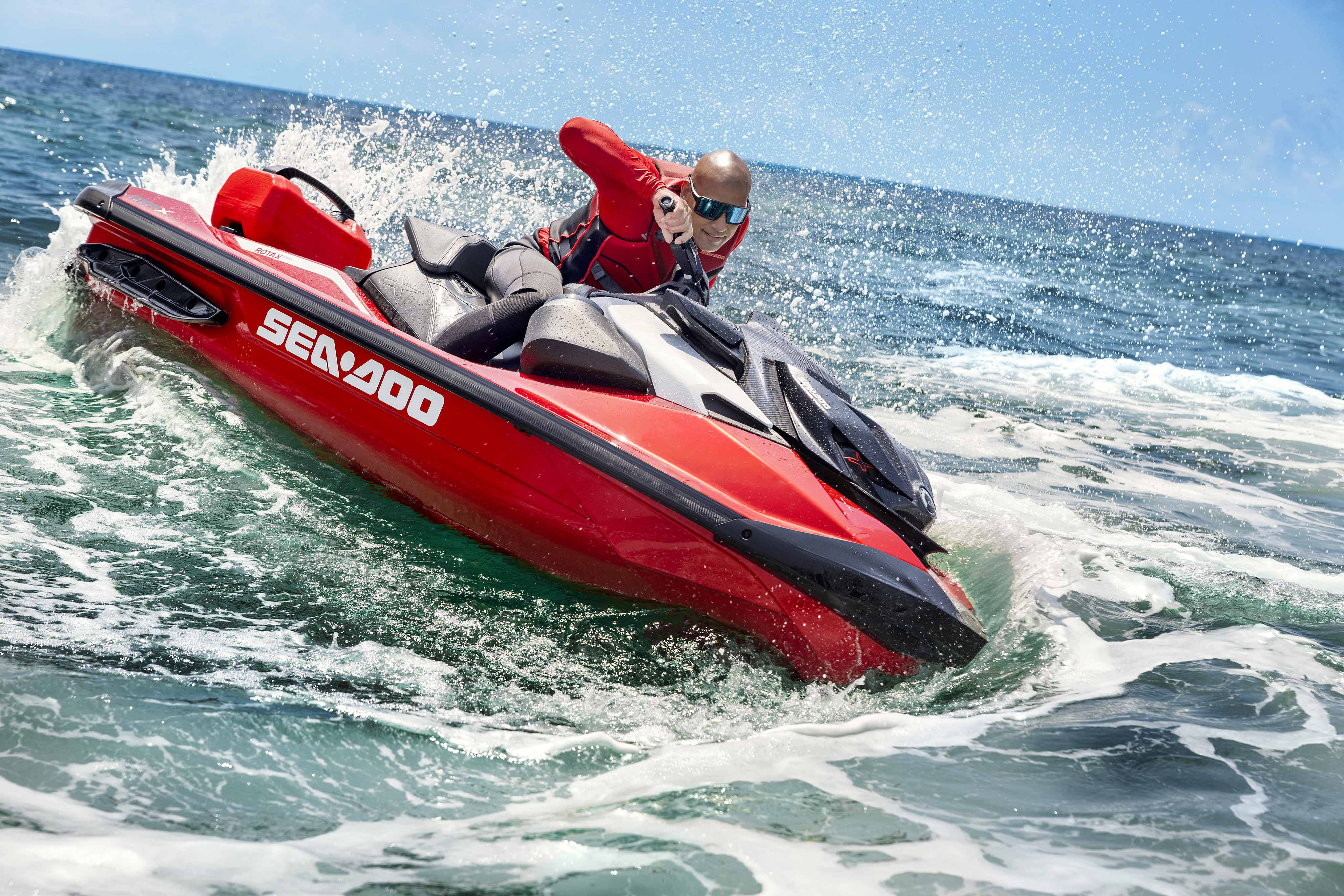 Couple riding a Sea-Doo Spark Trixx personal watercraft