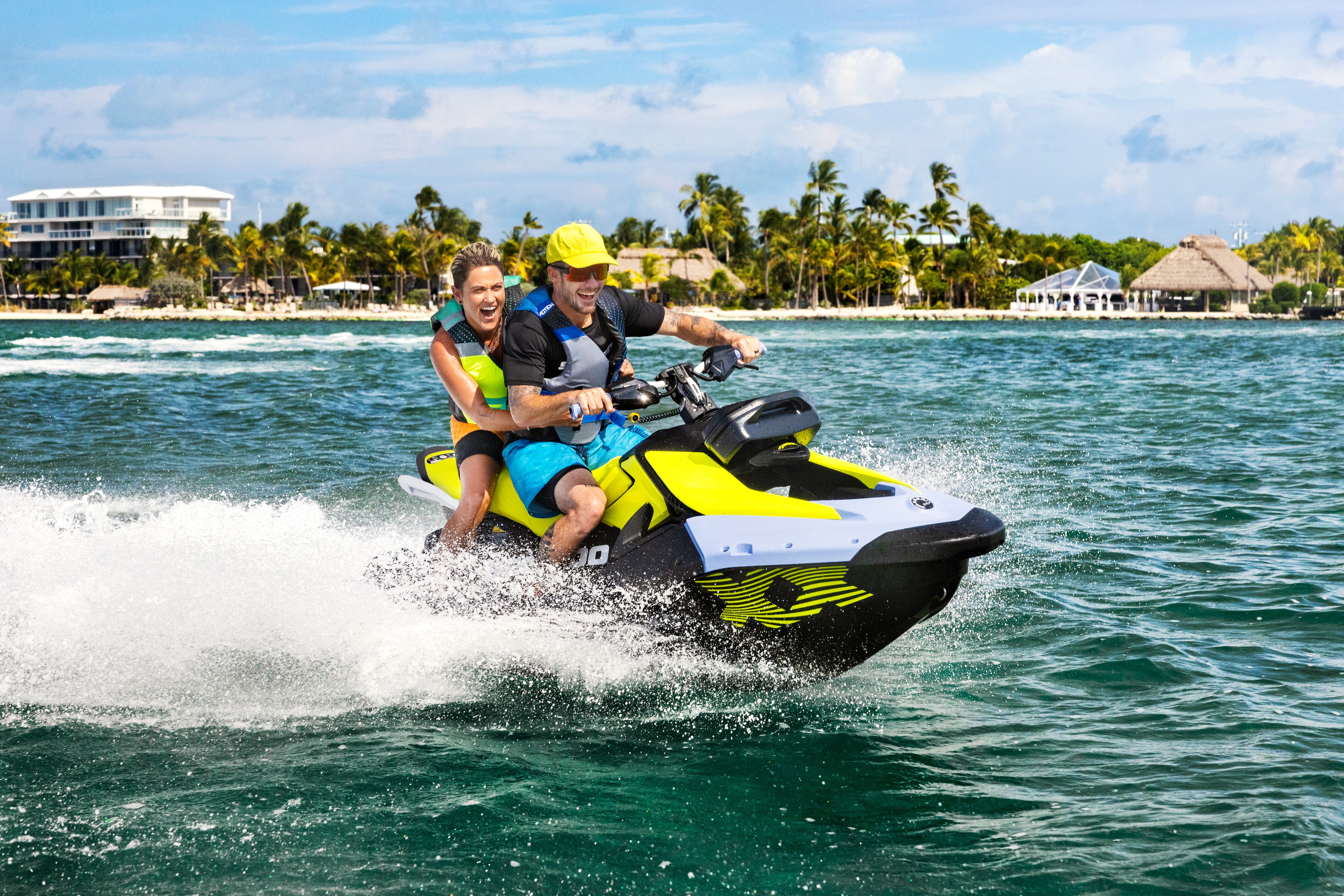 Couple riding a Sea-Doo Spark Trixx personal watercraft