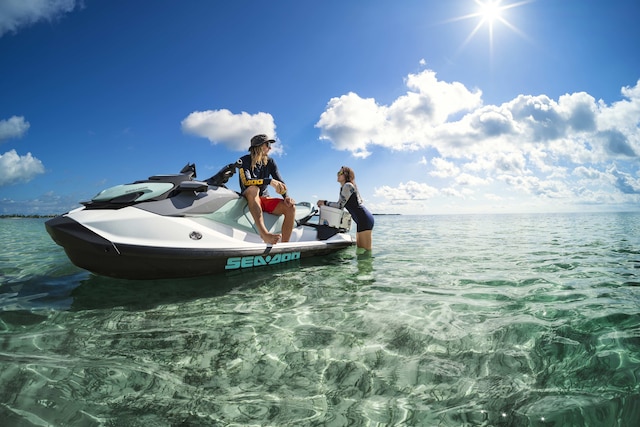 Two women talking on an idle recreational Sea-Doo GTI