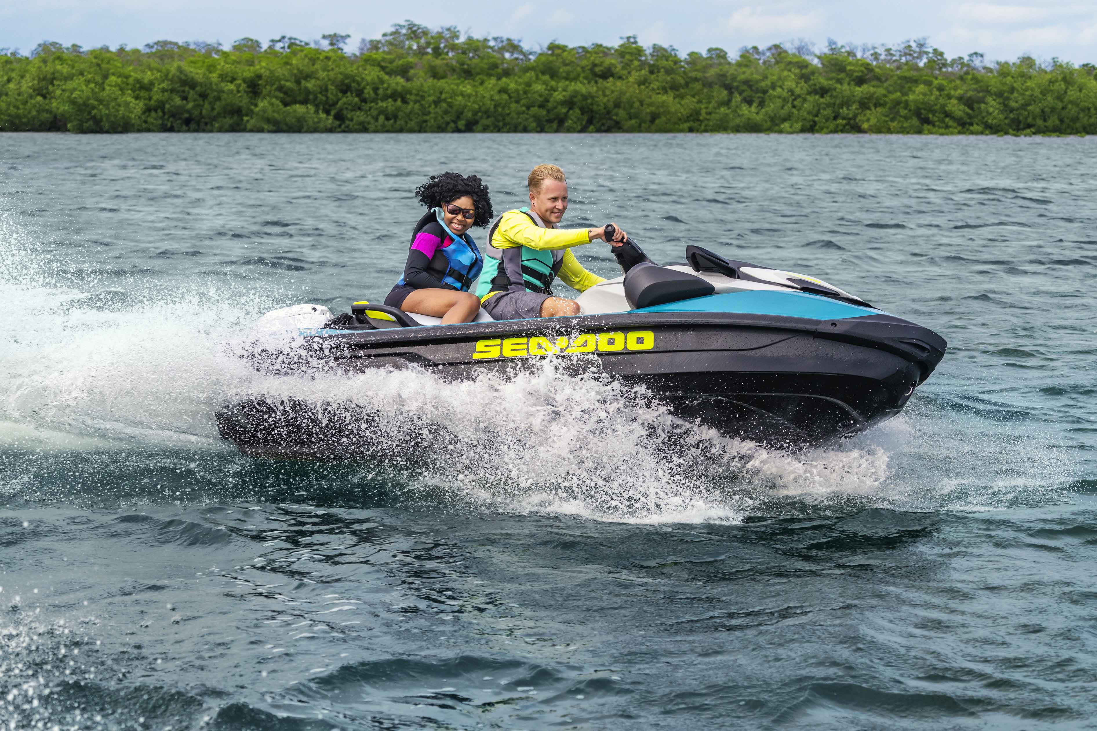 Couple riding a Sea-Doo GTI SE personal watercraft
