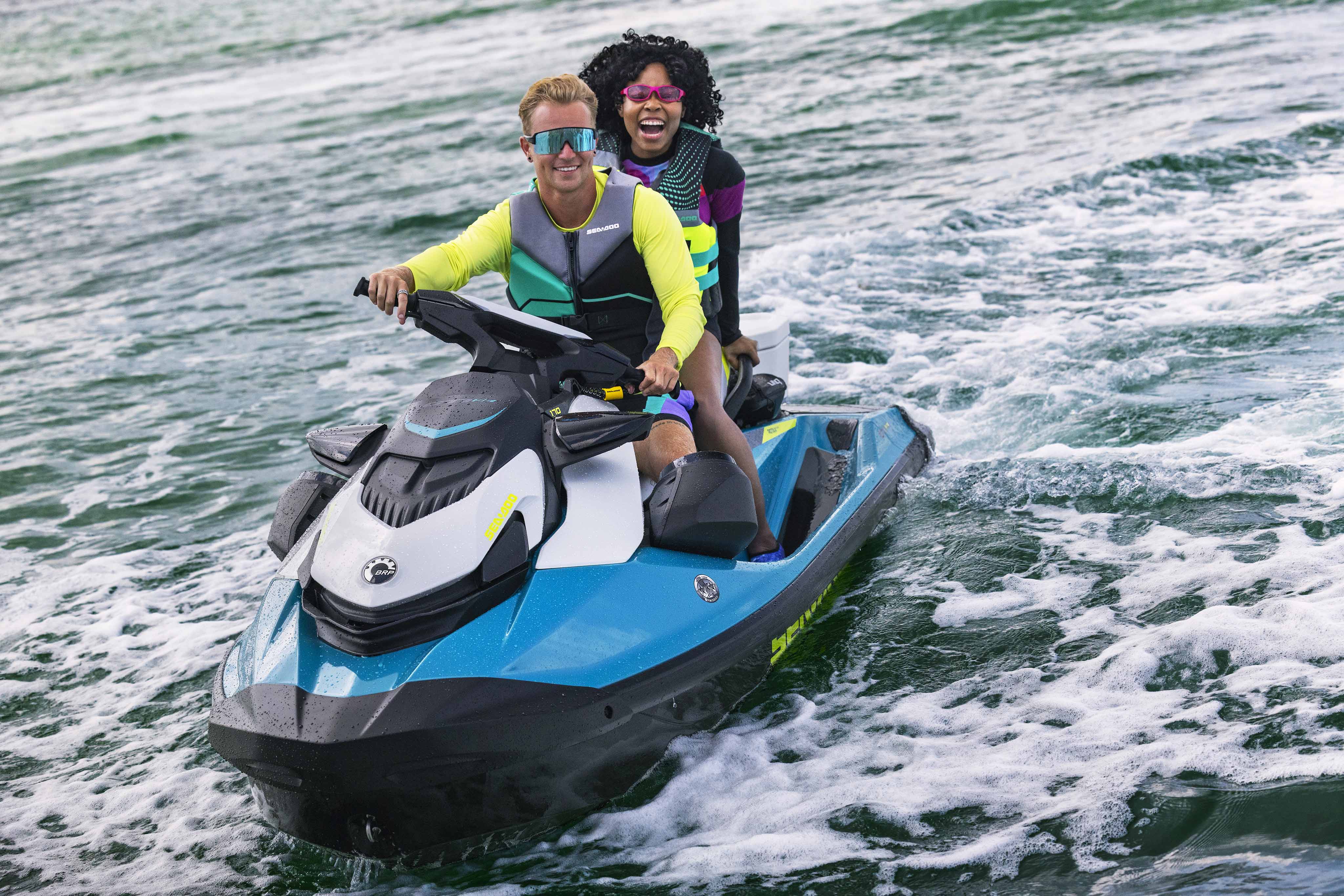 Couple sitting on their Sea-Doo GTI SE