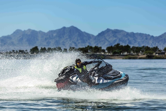 Man and woman sitting on a Sea-Doo GTX Limited personal watercraft