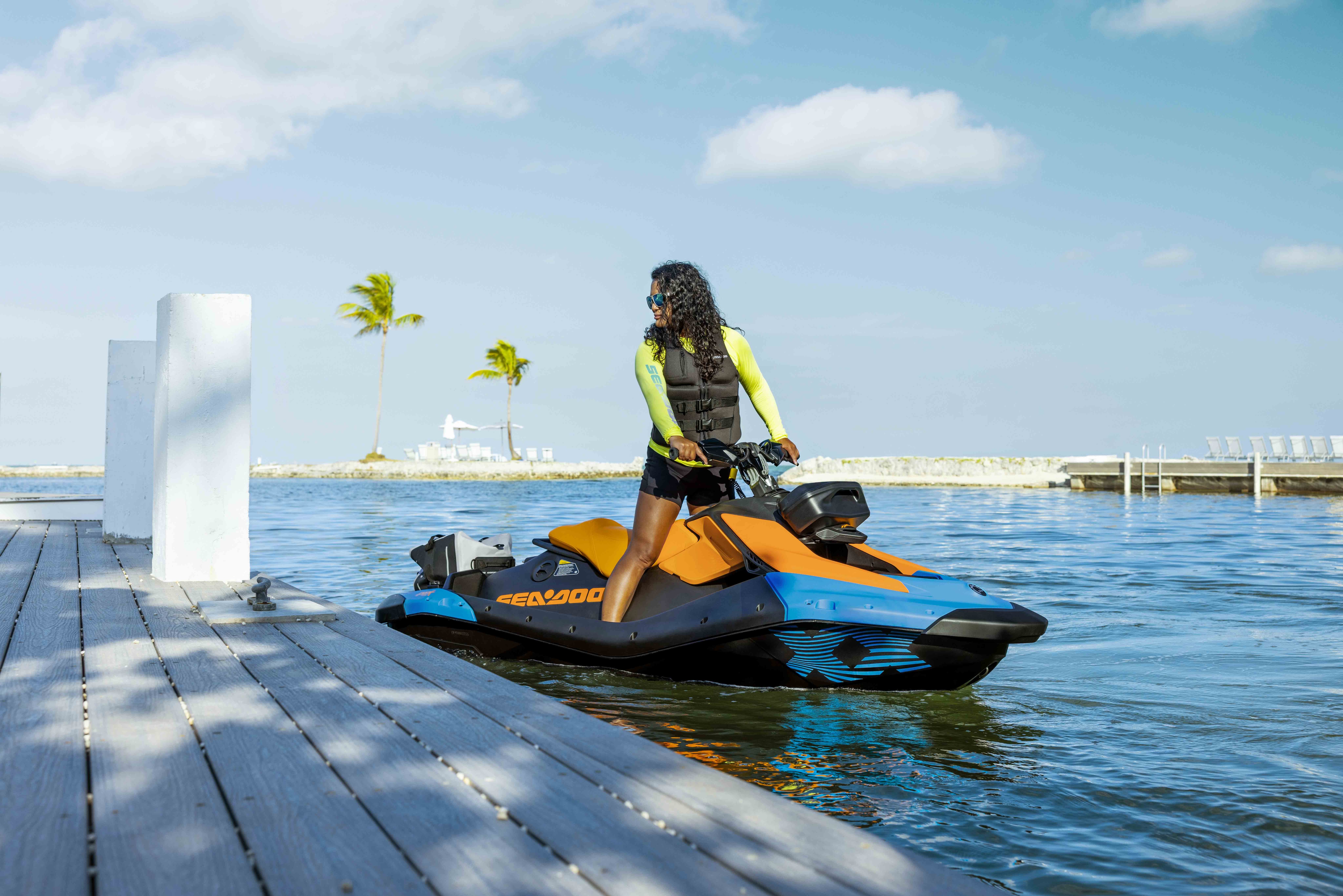 Couple riding a Sea-Doo Spark Trixx personal watercraft