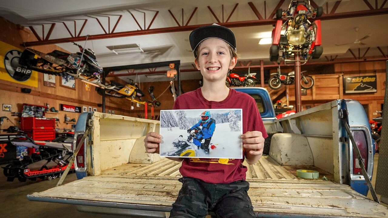 Carver Kuster holding a picture of his father, Ski-Doo Ambassador Carl Kuster