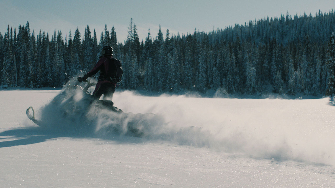 Sara Dufour riding a Ski-Doo in deep snow