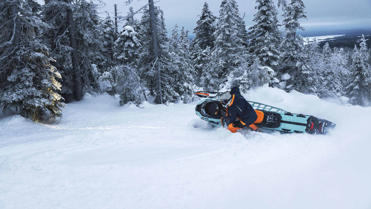 Men carving through powder with a Backcountry X-RS