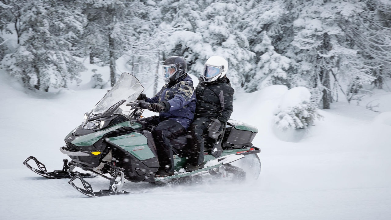 Couple enjoying a ride on the 2024 Ski-Doo Grand Touring