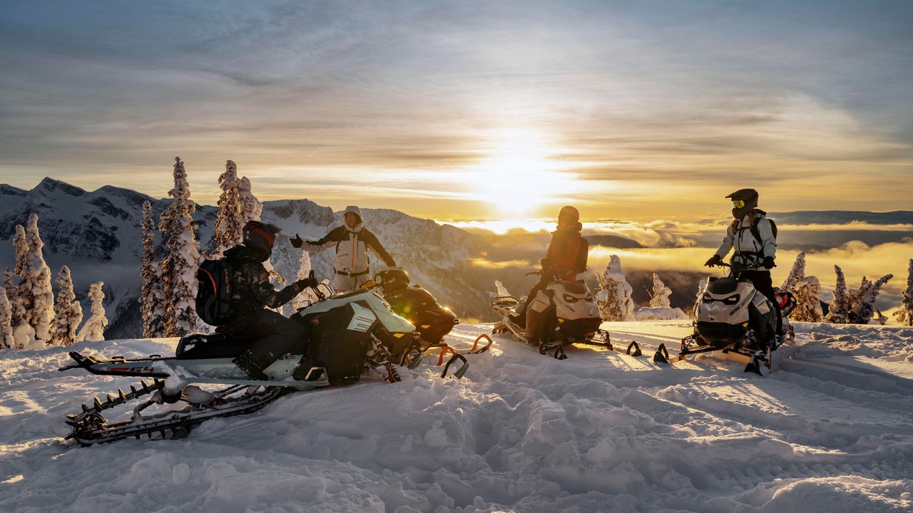 Groups of riders enjoying the sunset at the top of a mountain