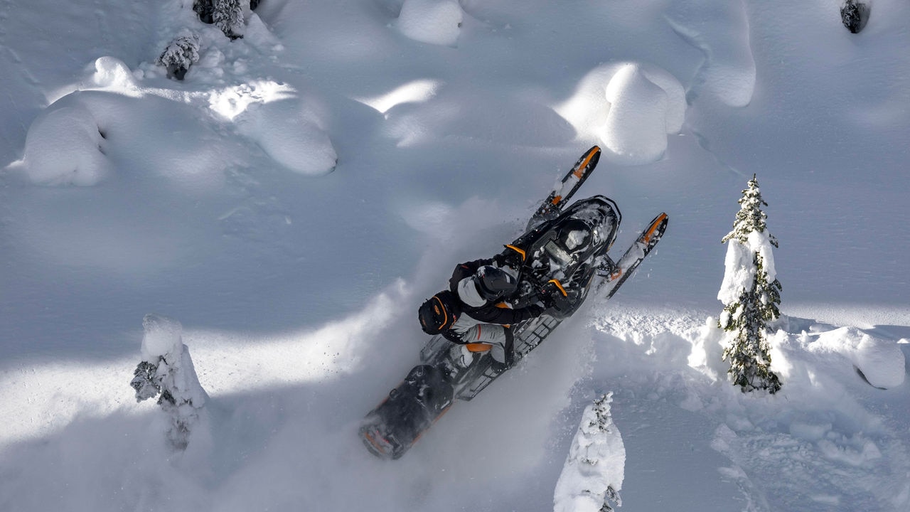 Man jumping in deep snow with the Ski-Doo Summit X with Expert Package
