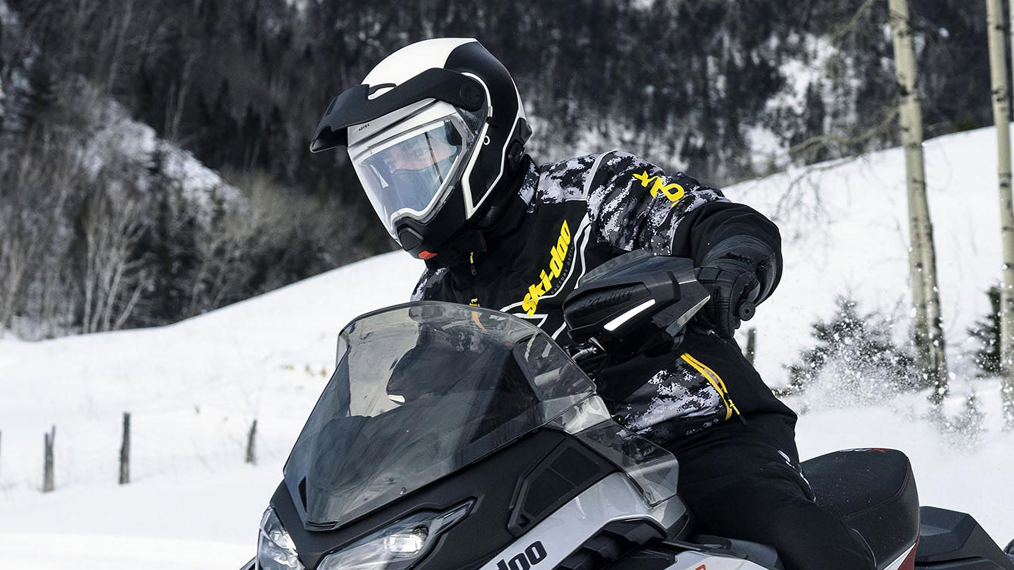 3 riders talking during a Ski-Doo snowmobile ride