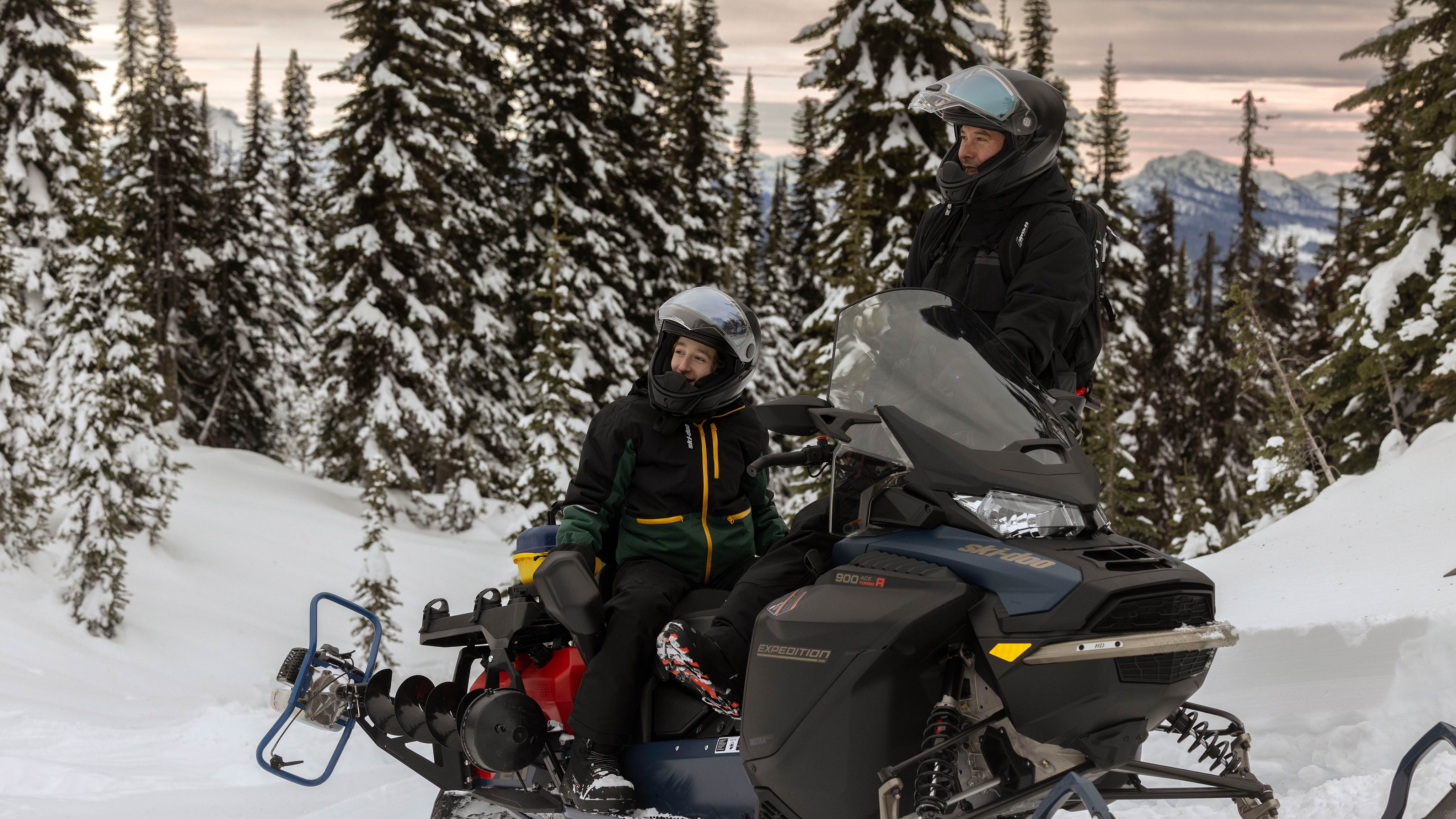 A dad ans his kid on a 2025 Ski-Doo Expedition SE