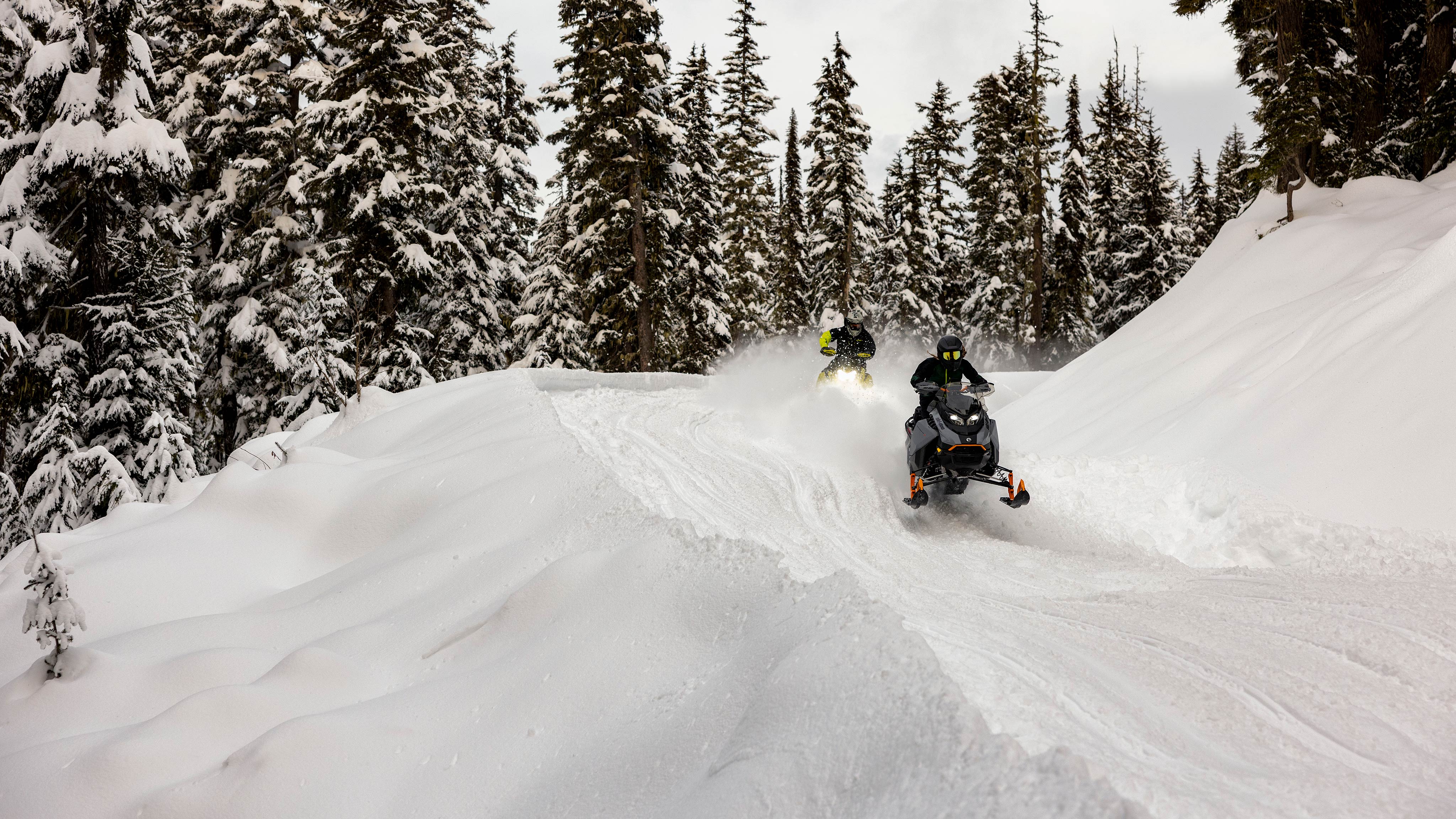 2025 Ski-Doo Crossover snowmobiles riding on a trail