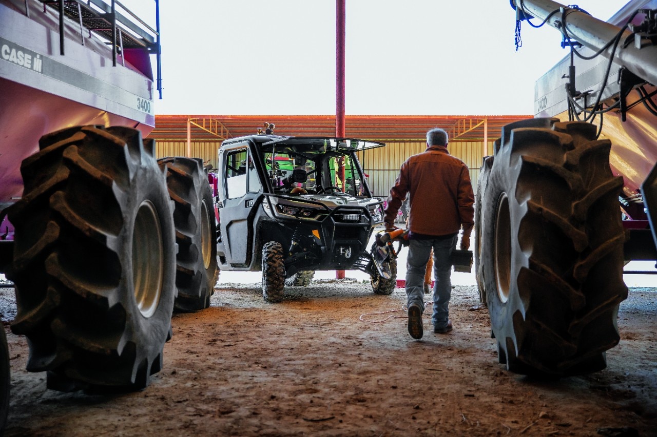 Man walking towards his Traxter in a farm