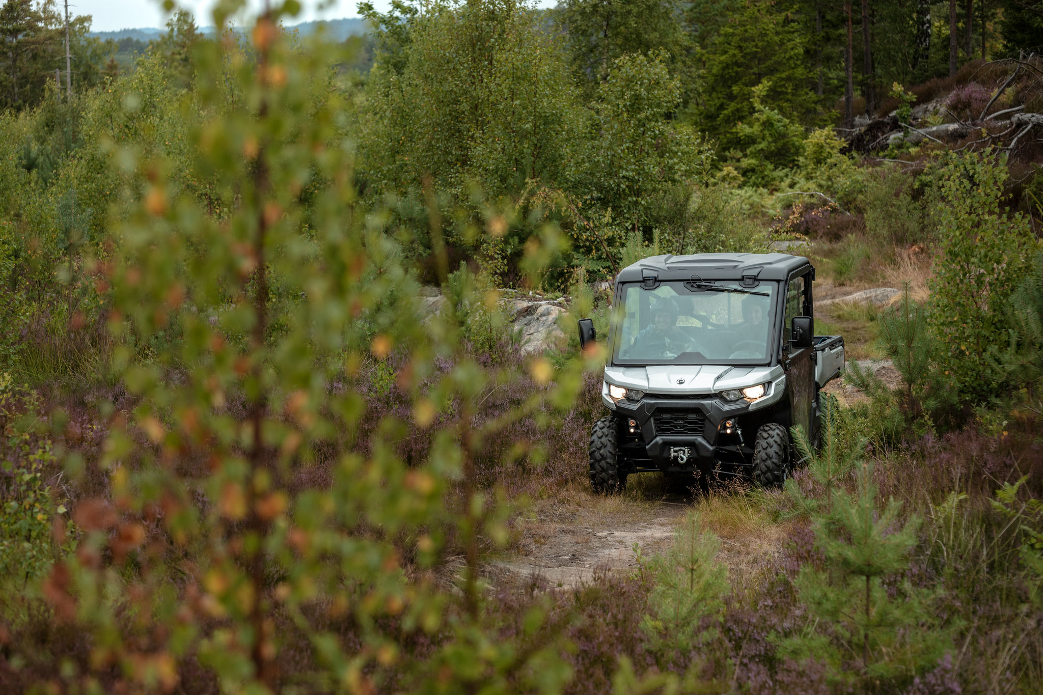 Maja Odden driving a forrest trail with her Traxter