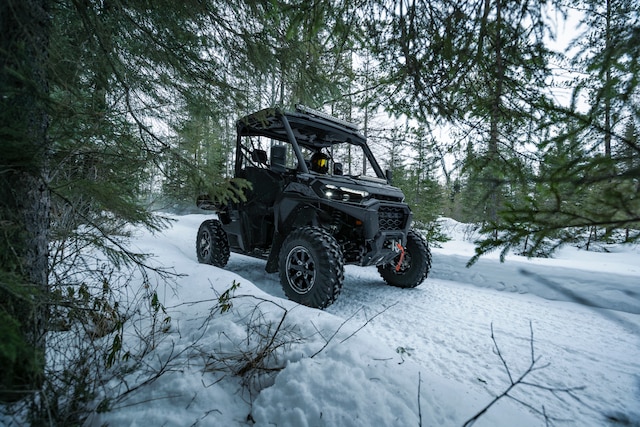 A Can-Am Traxter XU HD1 riding through a snowy trail
