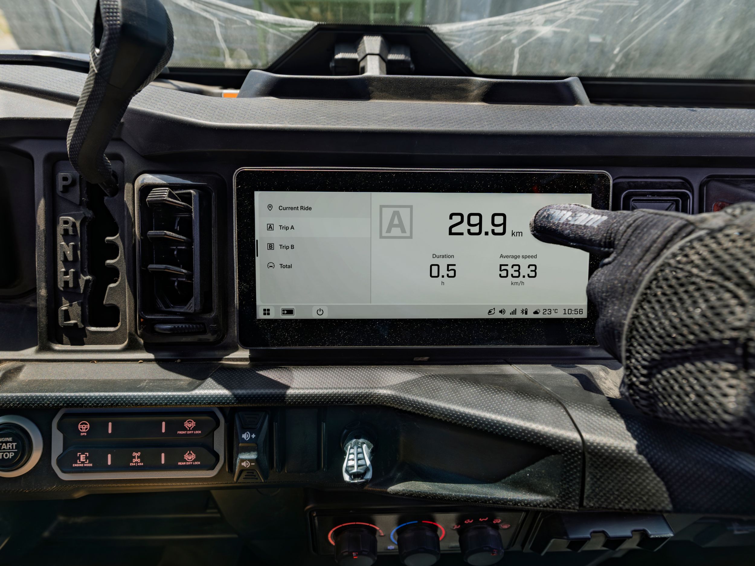 Passenger using the touchscreen display of the 2027 Defender SxS