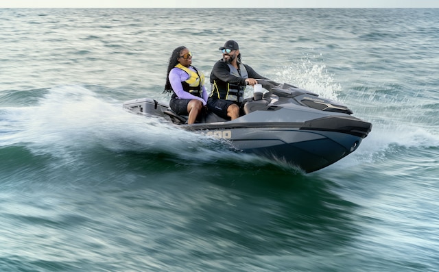 Couple enjoying an excursion on a 2027 Sea-Doo GTX Limited personal watercraft equipped with a LinQ cooler