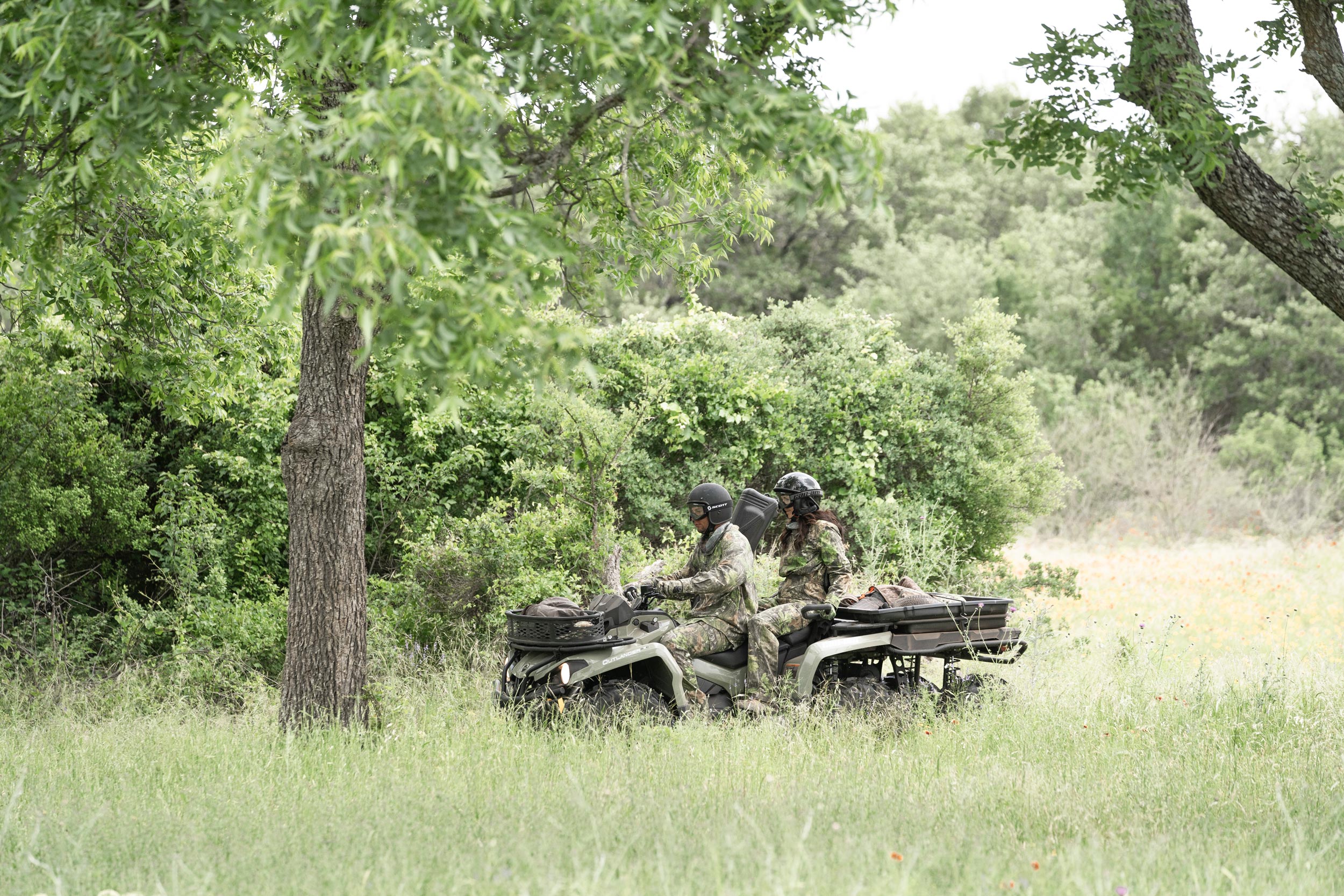 Two hunters riding a 2-seater Can-Am Outlander MAX 6x6 DPS ATV