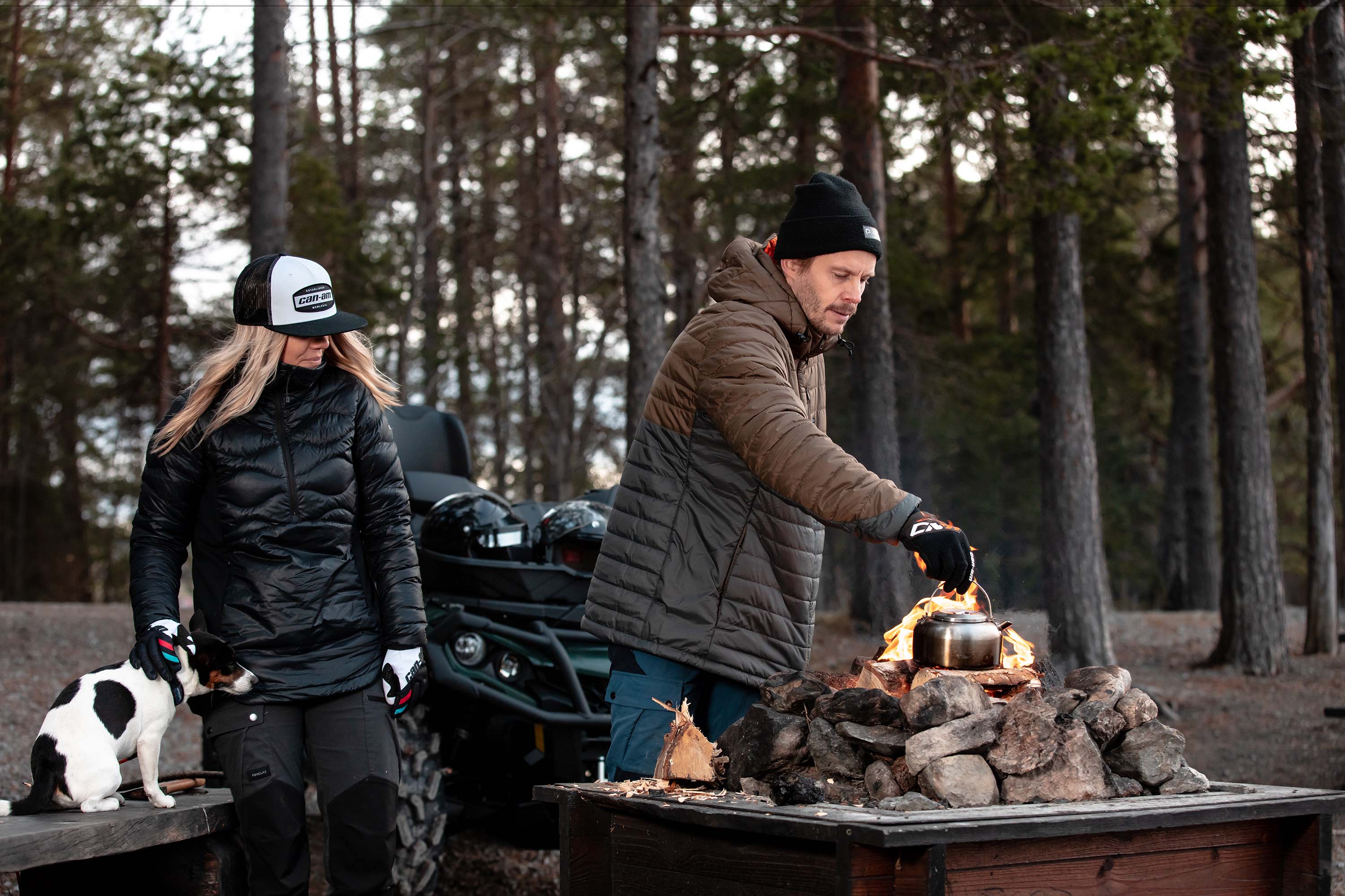 Couple with their dog in front of campfire