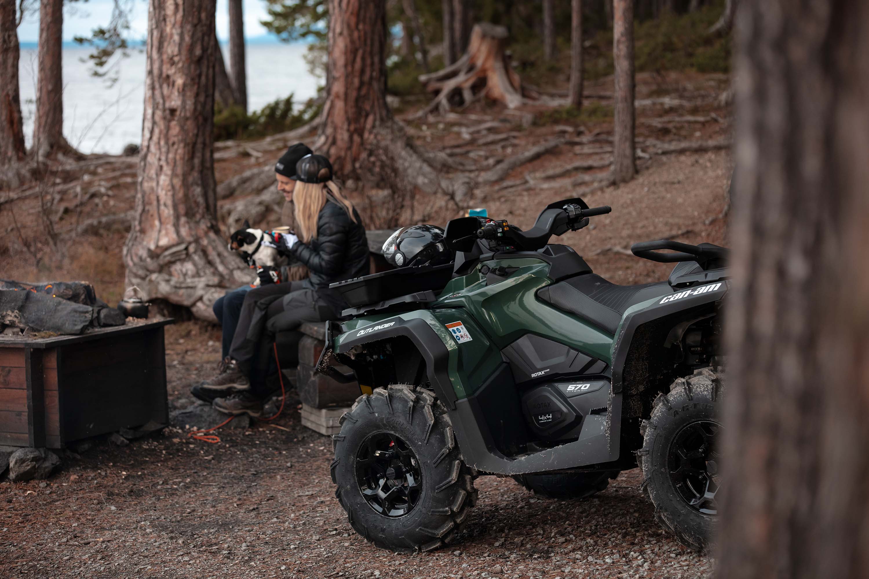 Couple with their dog in front of campfire