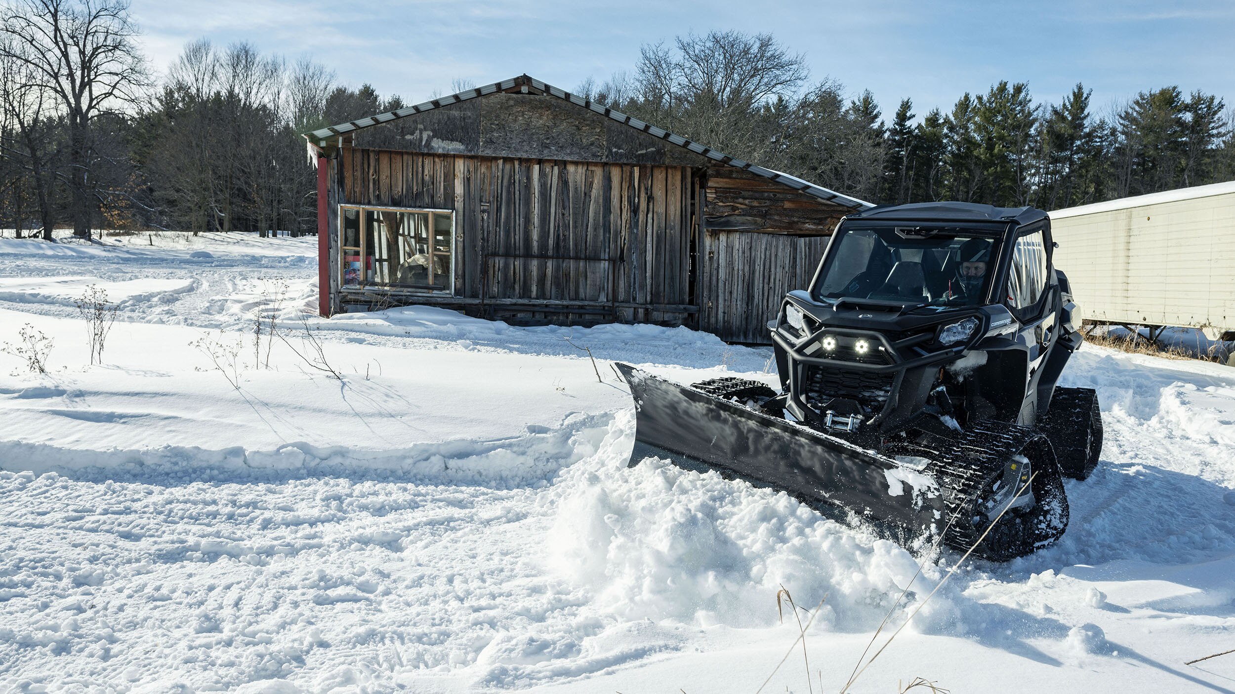 Commander XT plowing a wintery road, equipped with Apache Tracks