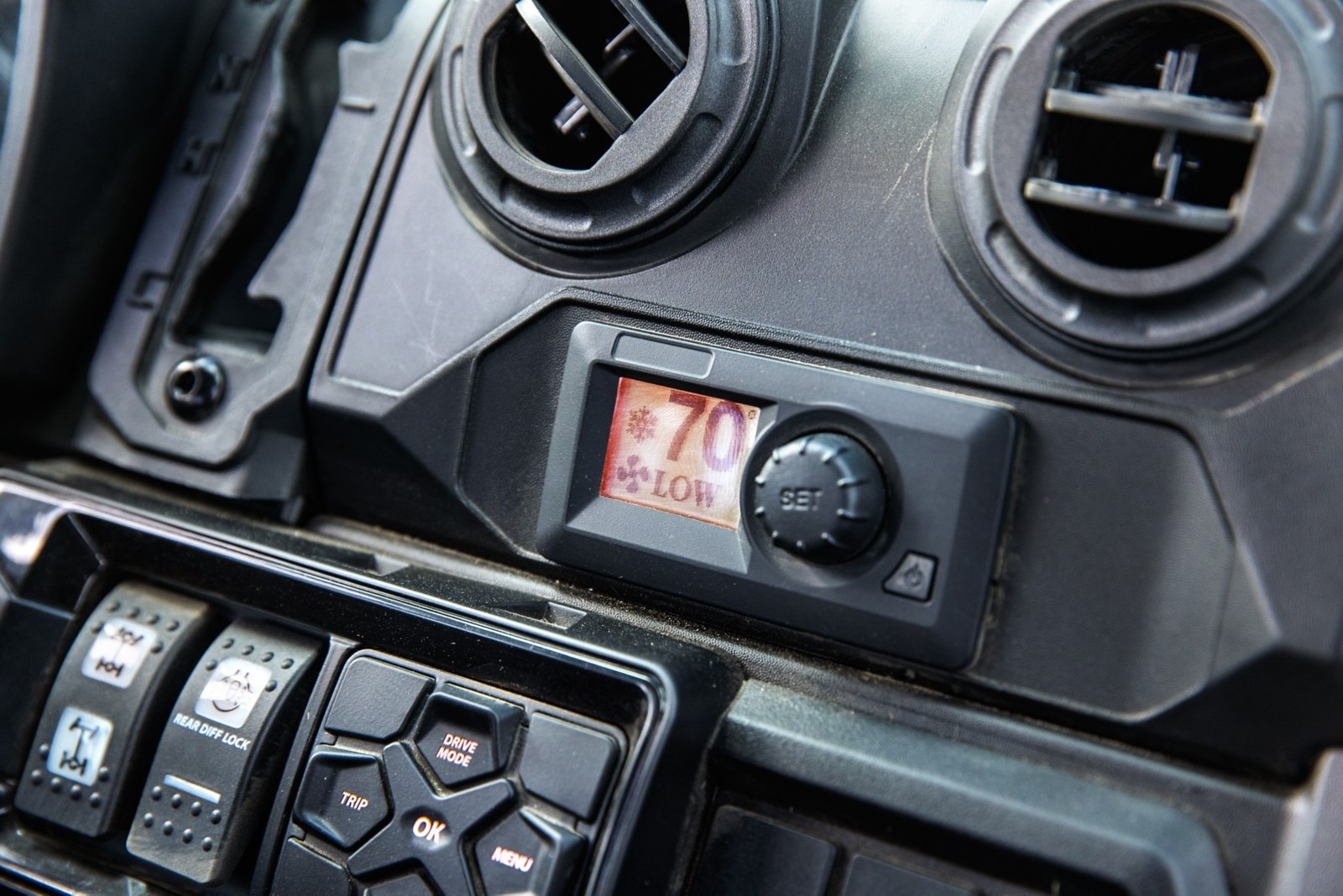 Can-Am Defender cockpit photo featuring the HVAC system and its controls