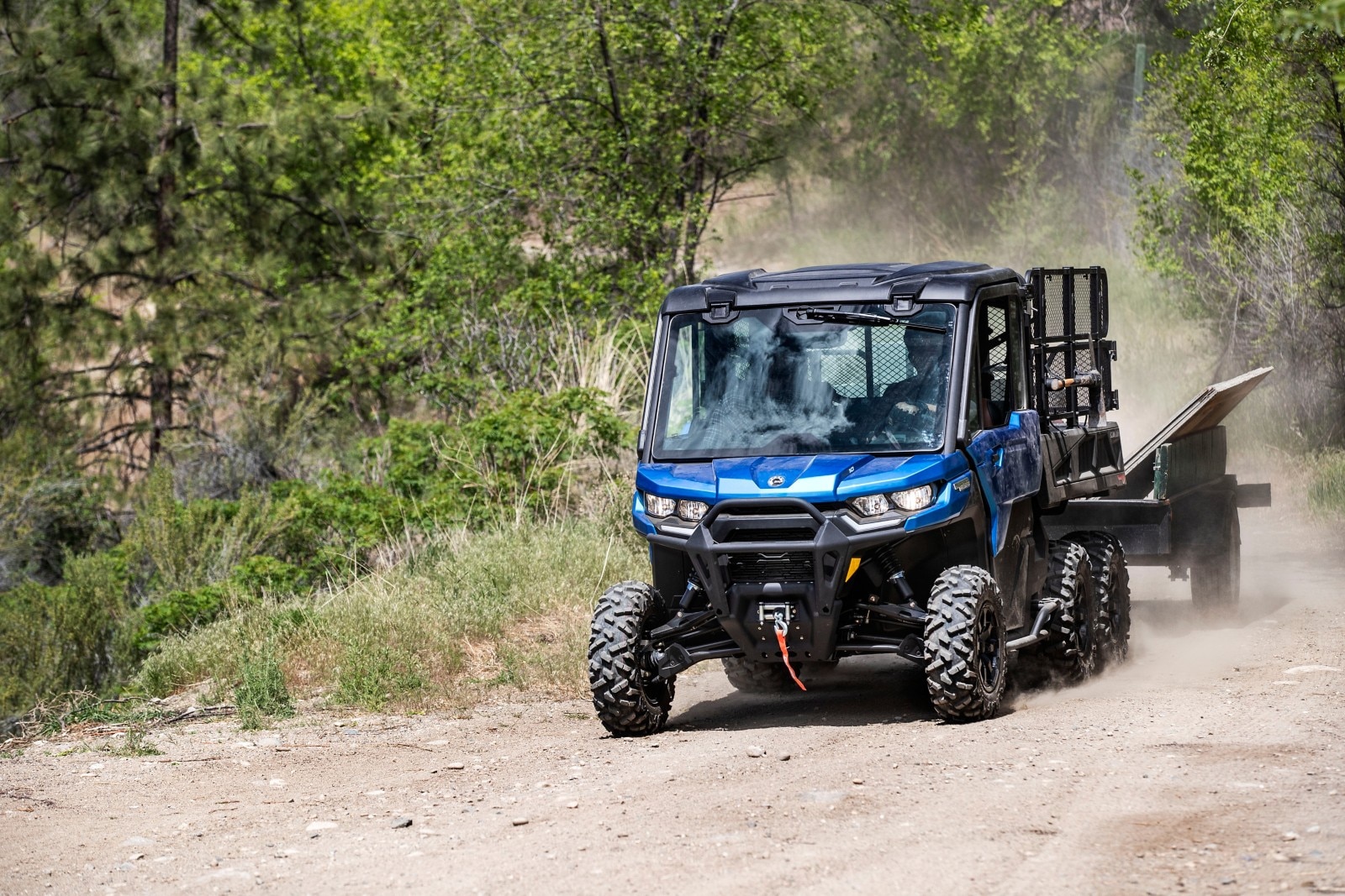 An Oxford Blue Can-Am Traxter 6x6 Limited in action, hauling a trailer