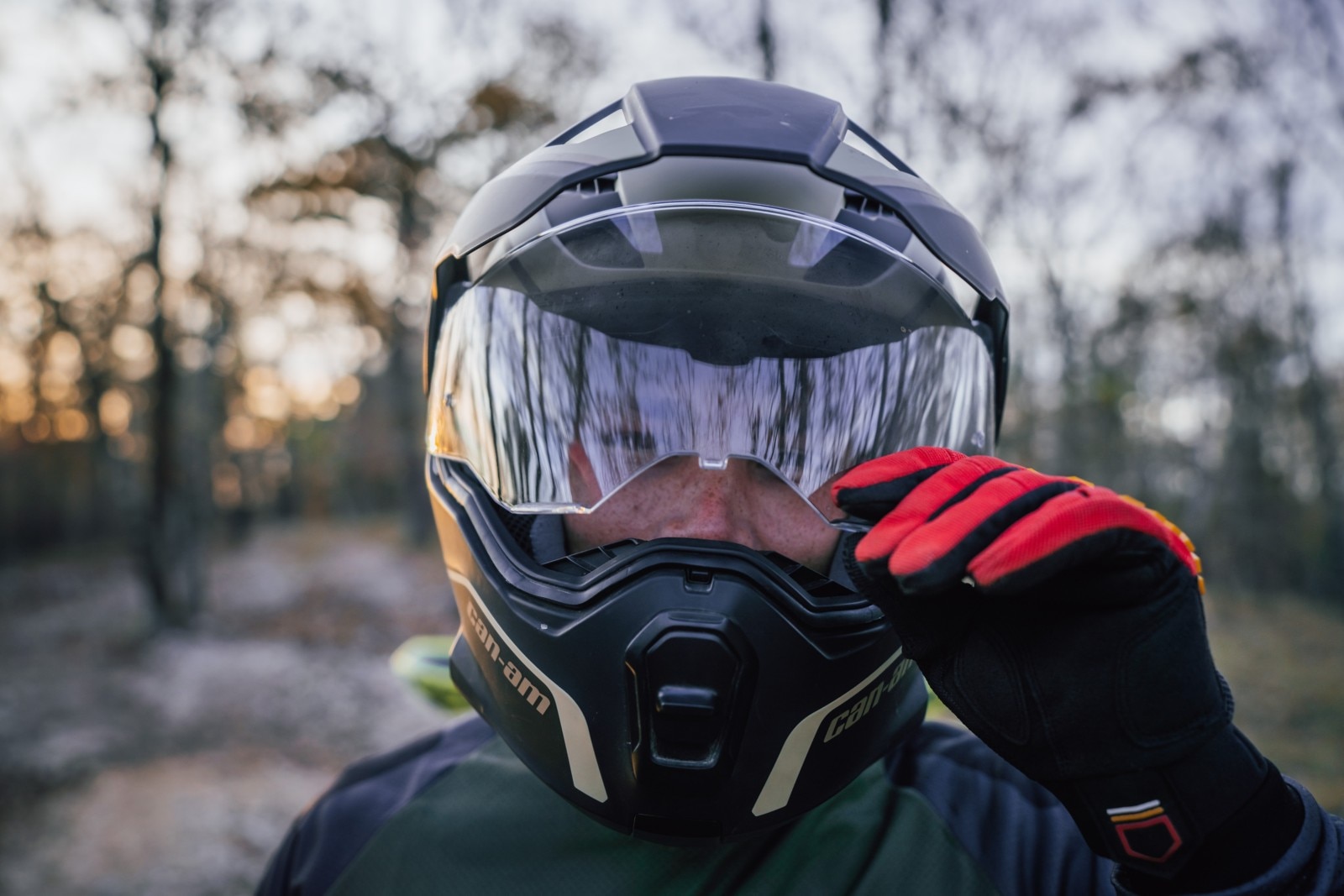 Close-up of a rider opening the visor of their Can-Am Exome Helmet
