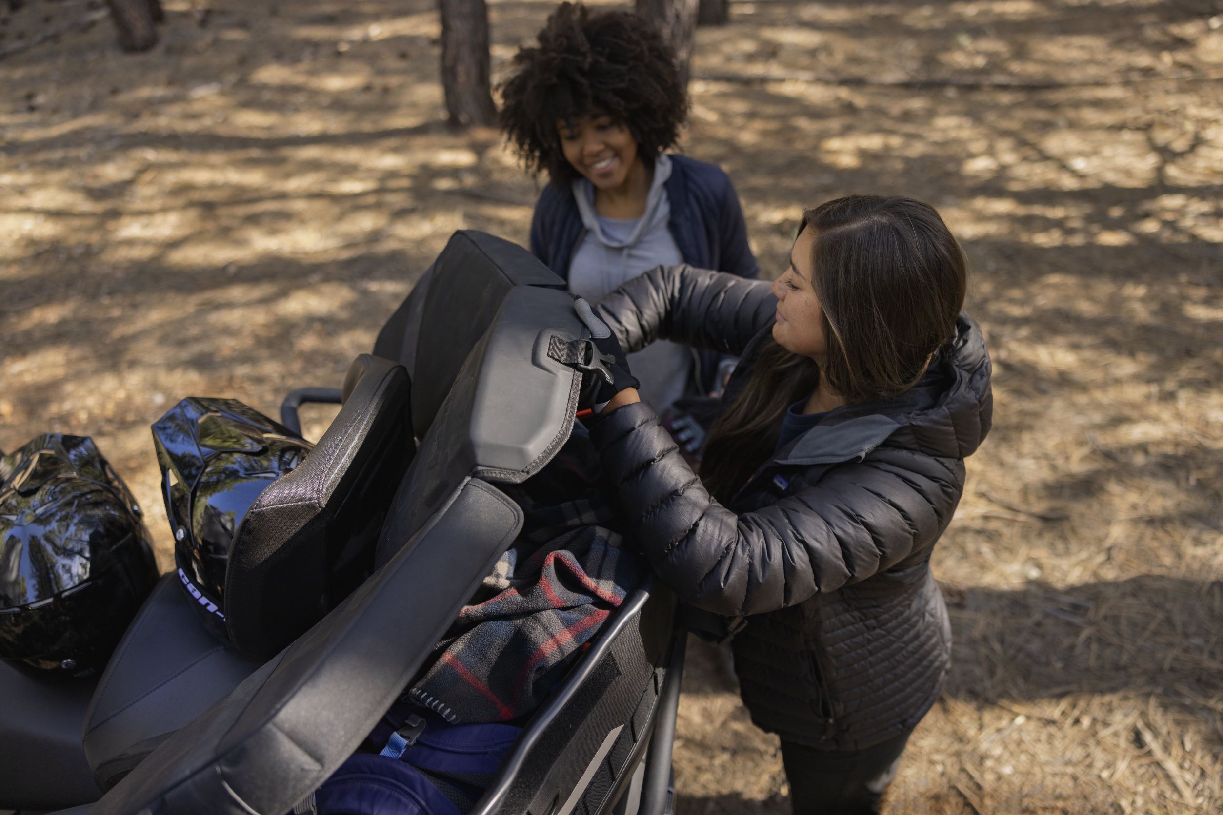 Women load gear on Outlander MAX XT 850