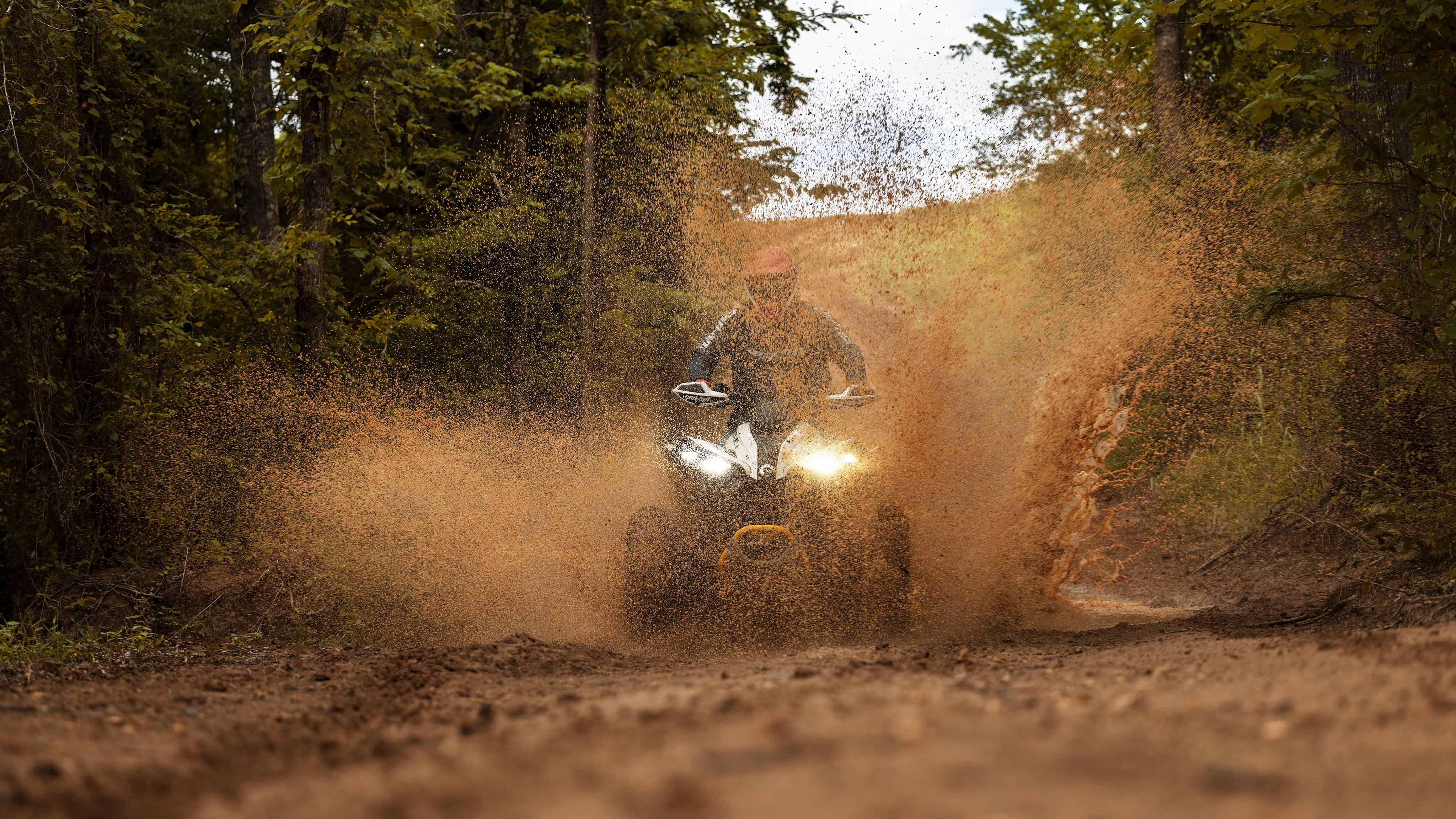 A Can-Am Renegade sends mud flying