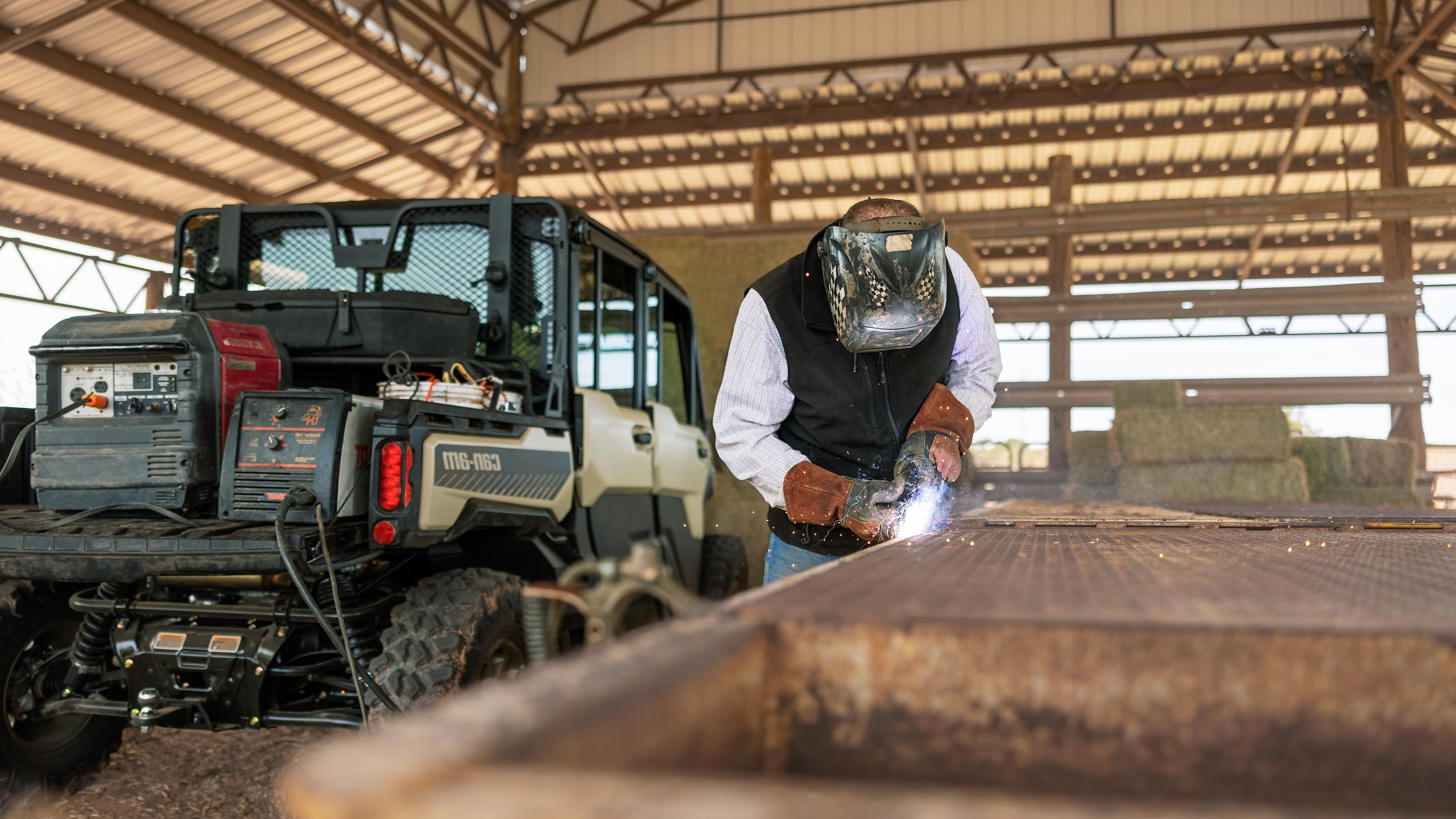 Man welds beside Defender MAX Limited