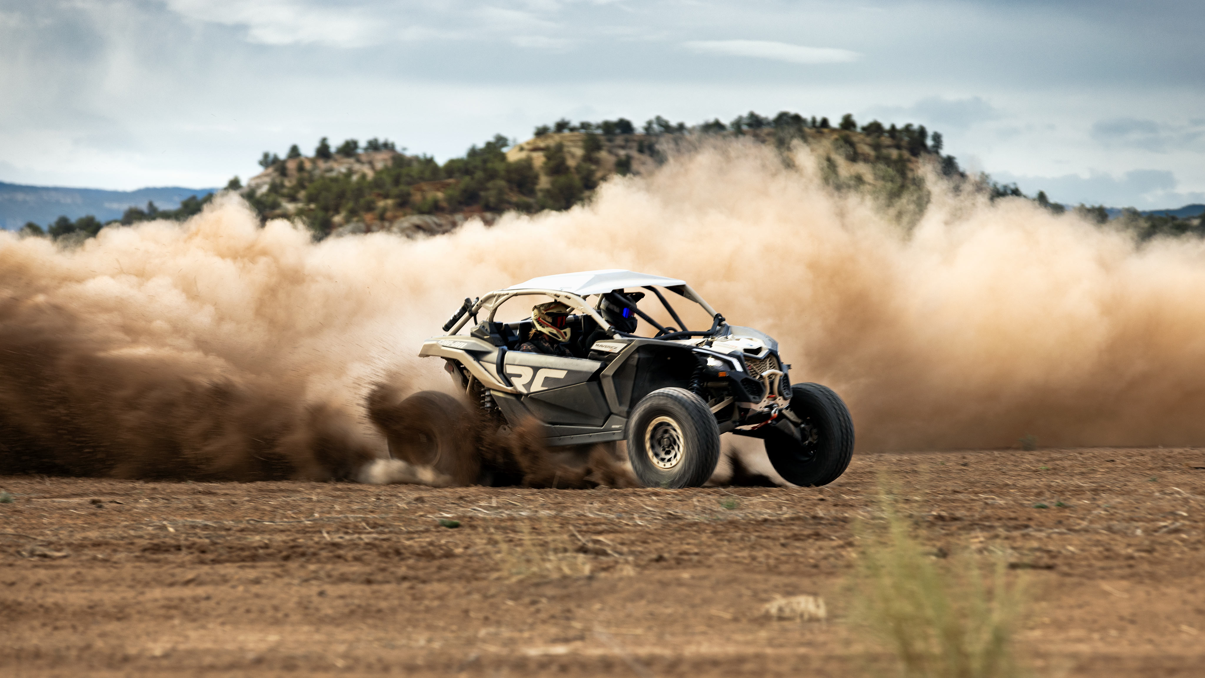 Man driving a Can-Am Maverick in the sand