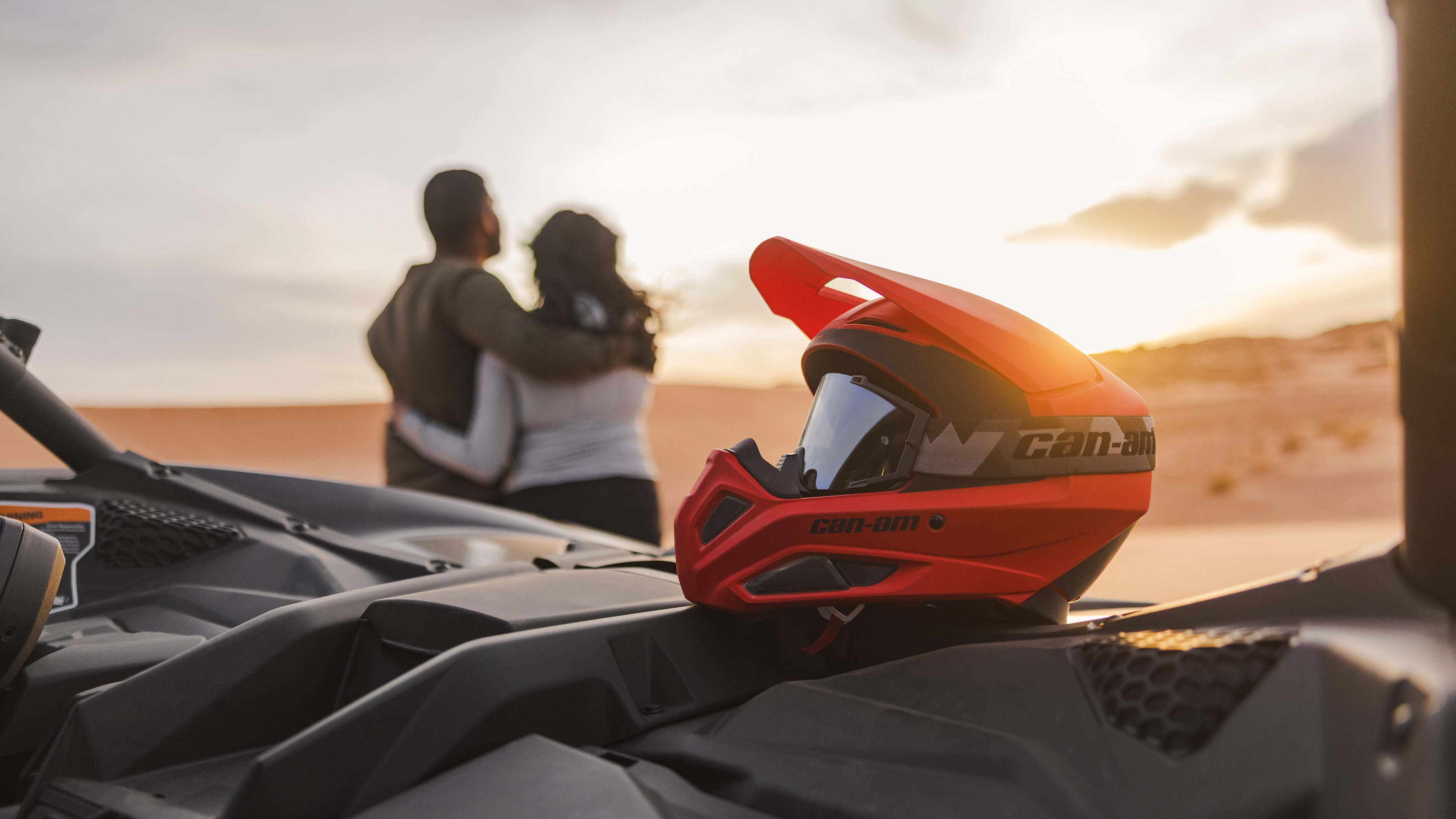 Can-Am helmet with two people in the background