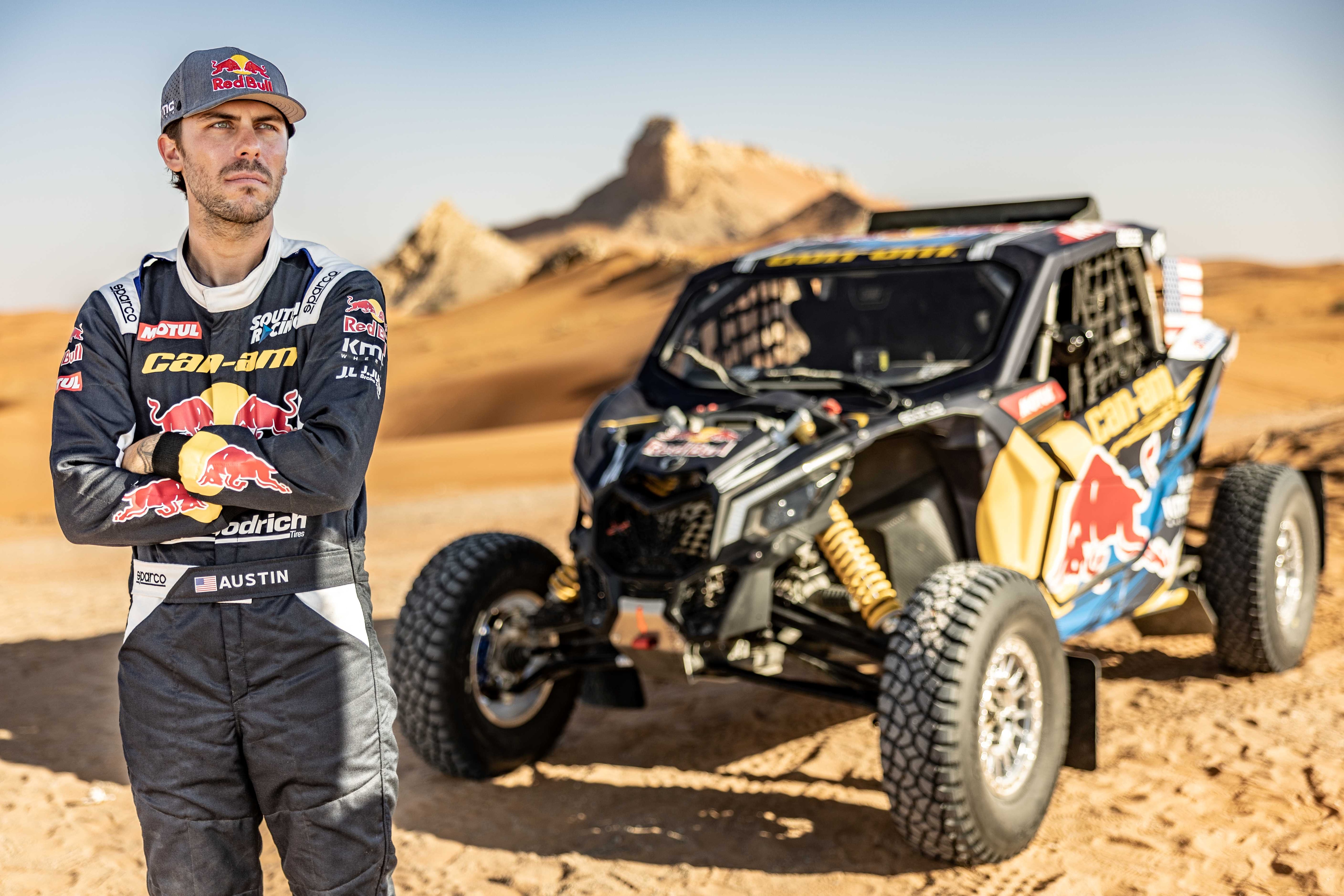 AJ in front of his Maverick vehicle during Dakar 2023