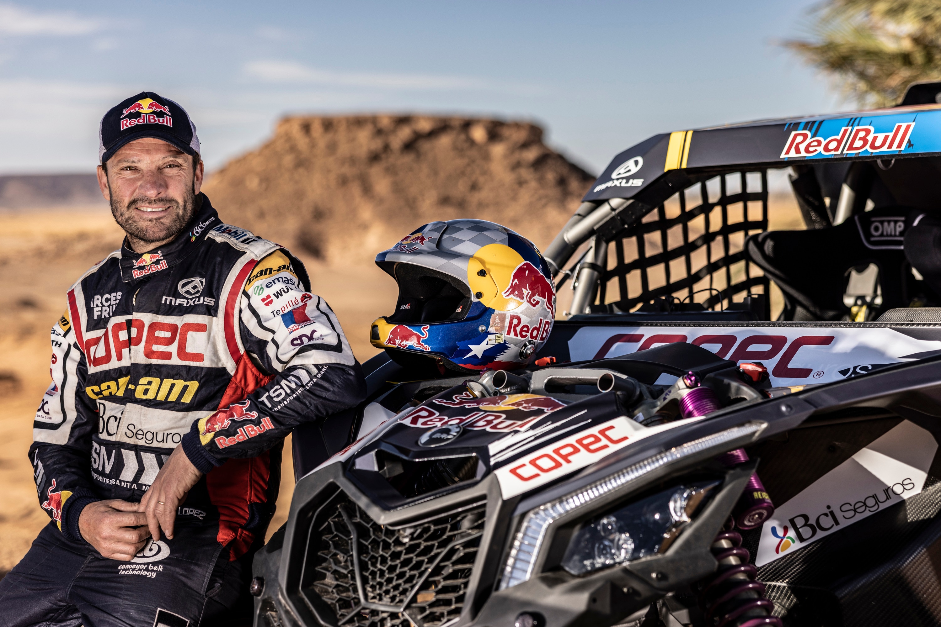 Chaleco Lopez next to his vehicle looking at the camera