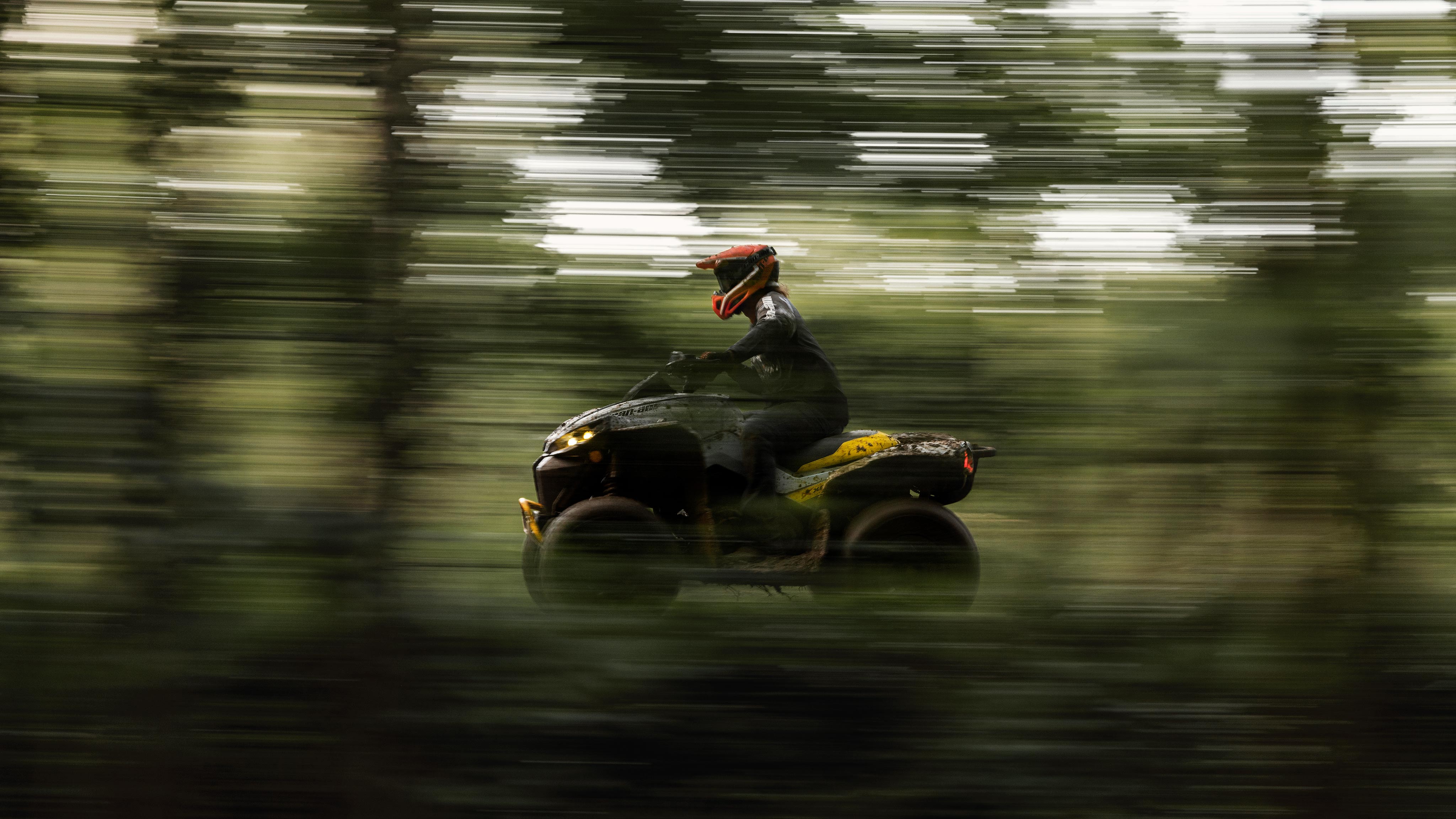 Person riding a Can-Am Outlander ATV in high speed