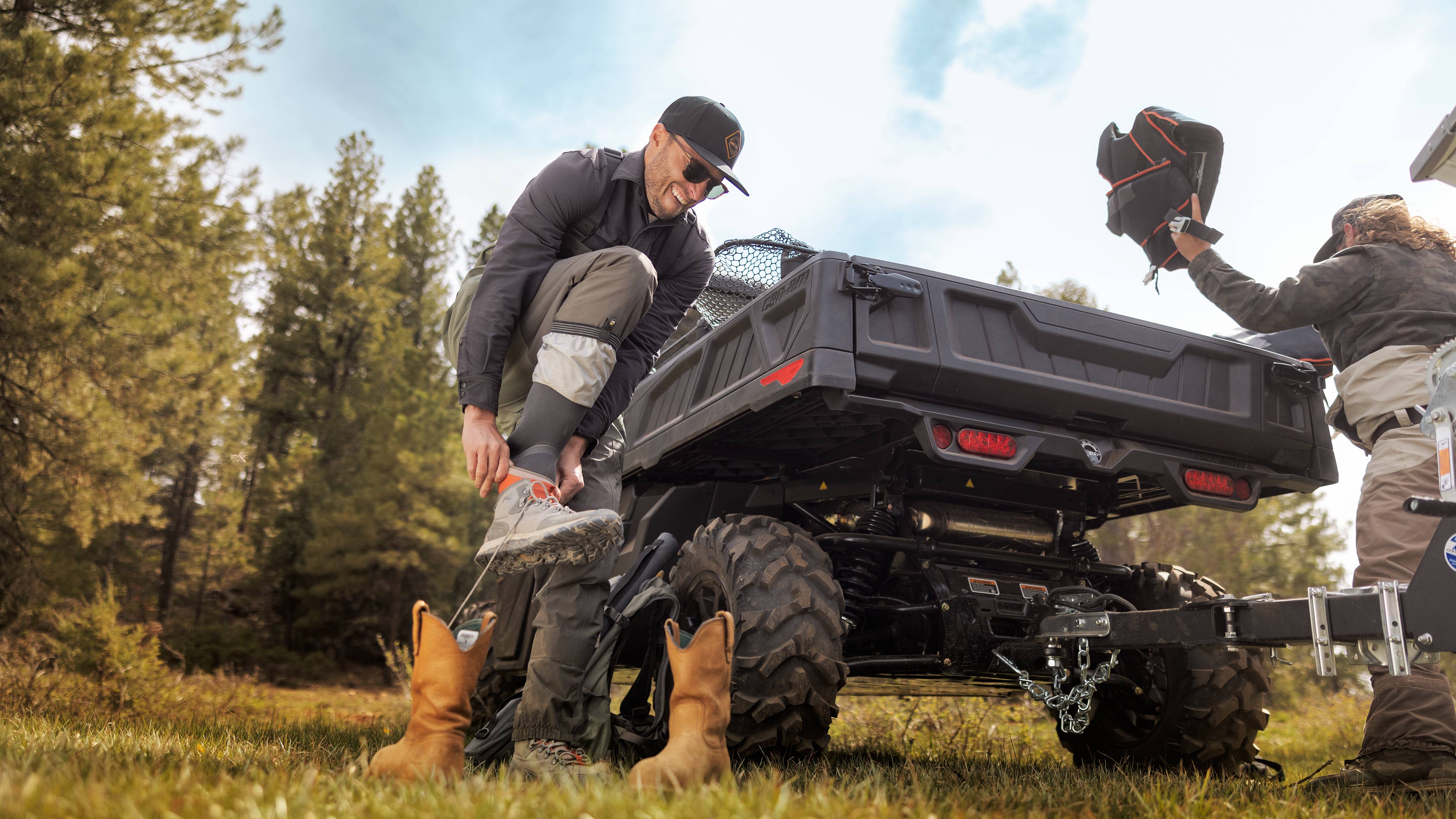 Man standing next to Can-Am Traxter 