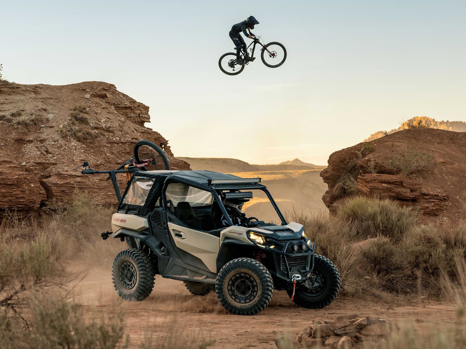 A cyclist making a jump near a Can-Am