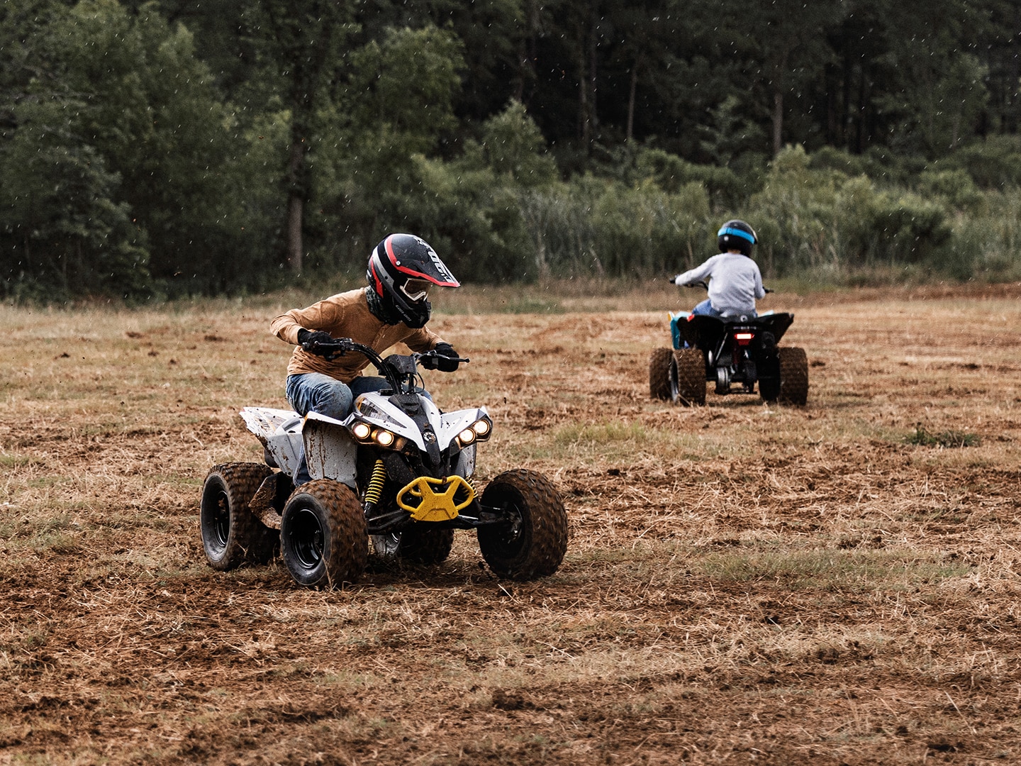 Young riders driving on Can-Am ATVs