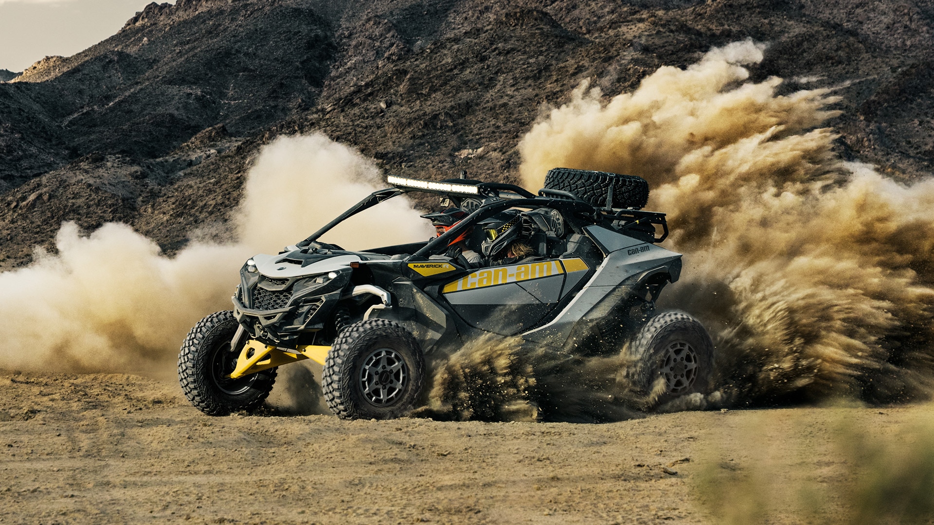 Man driving a Can-Am Maverick R in the sand