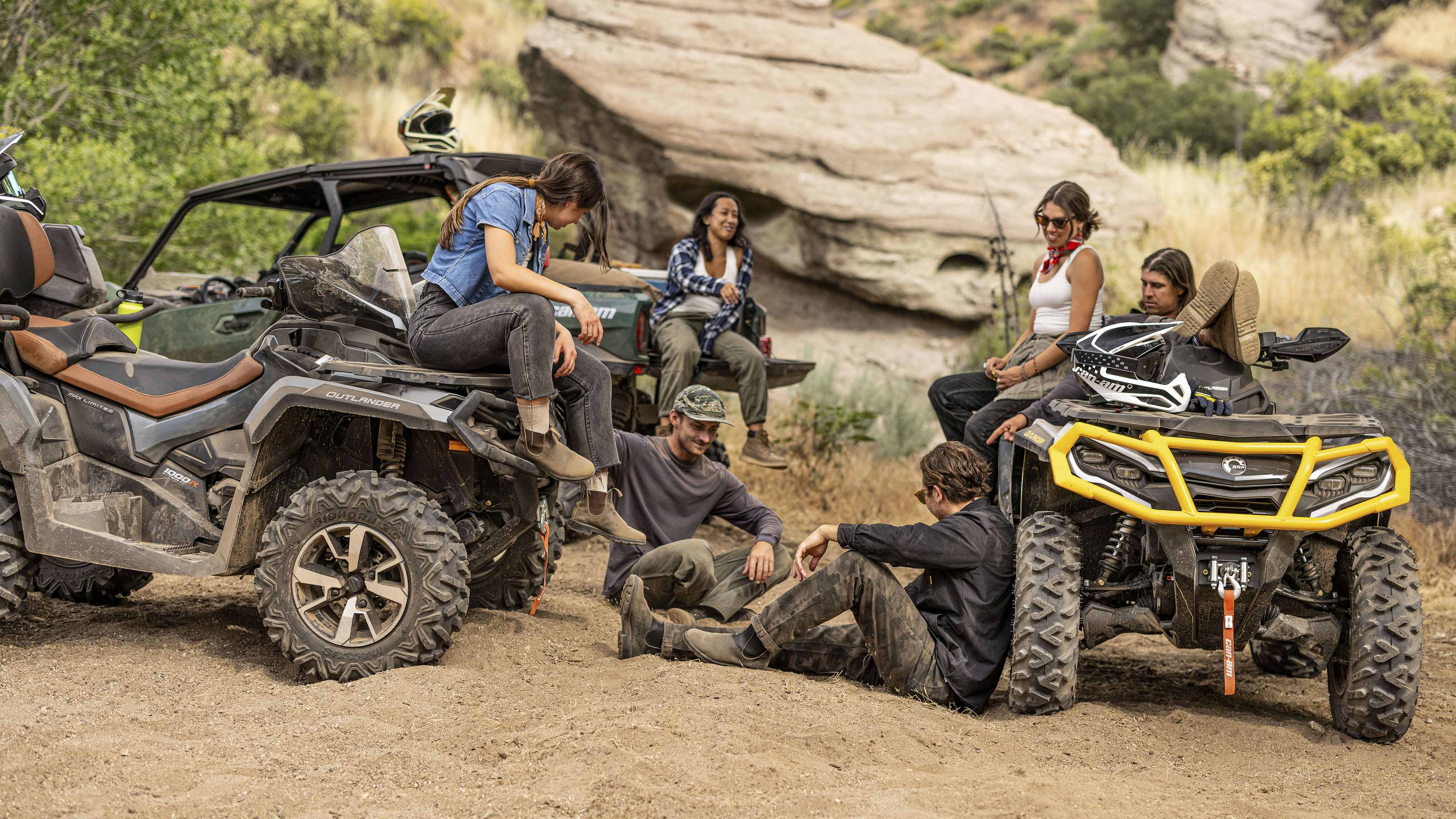 Group gathered around Can-Am off-road vehicles