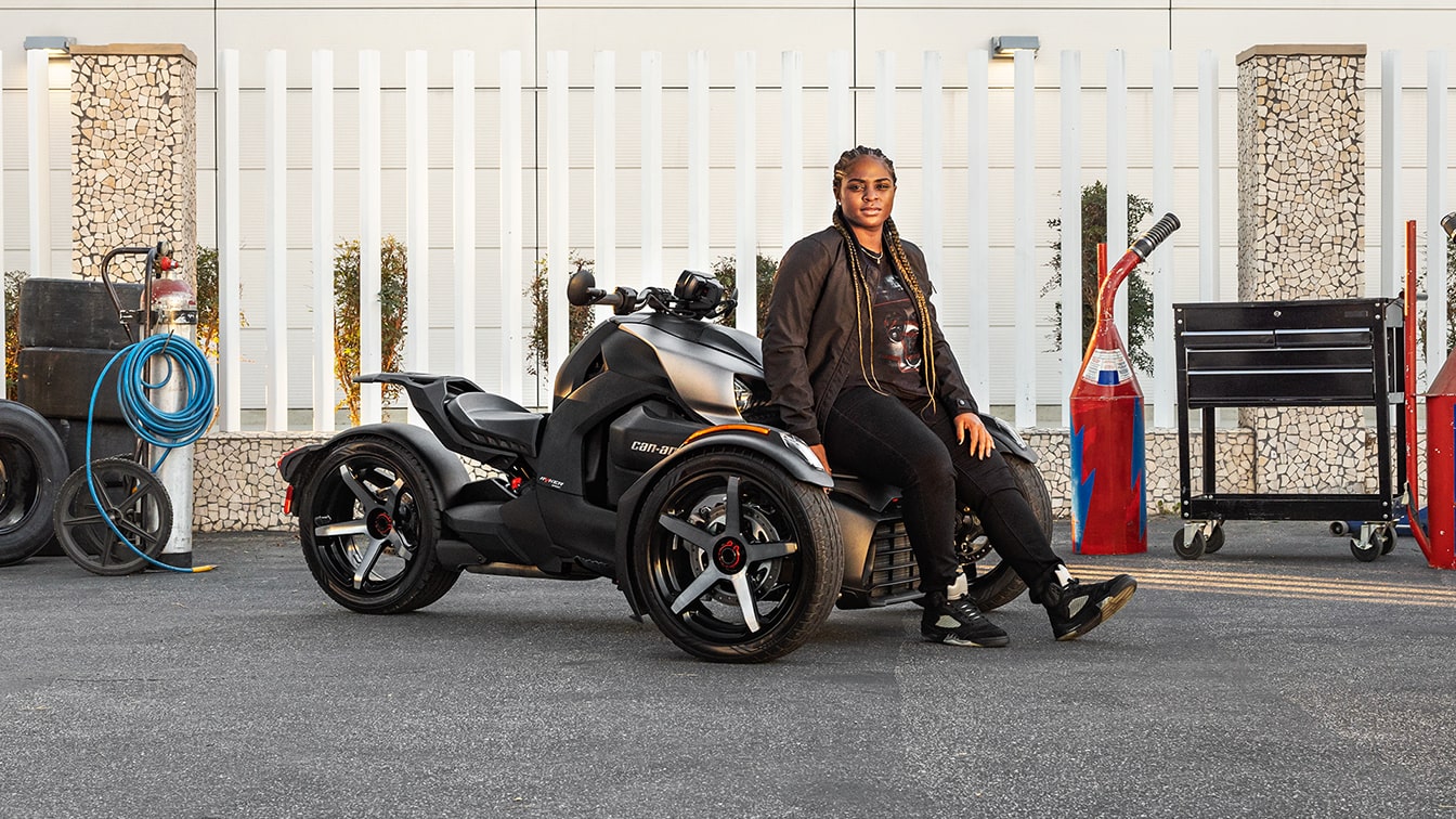 Women posing on her Can-Am Ryker 3-wheel motorcycle